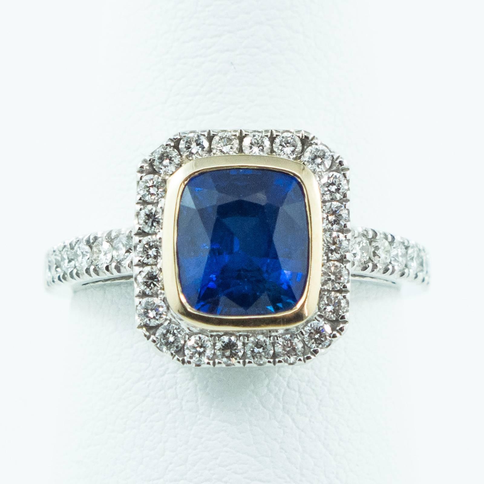 This lovely Brilliant Cut Sapphire, Diamond and Gold Ring features 36 bead set round, brilliant cut diamonds surrounding the beautiful Blue Sapphire/Corundum which is set in a yellow gold bezel.

The ring rises up 7mm off the top of your finger. It