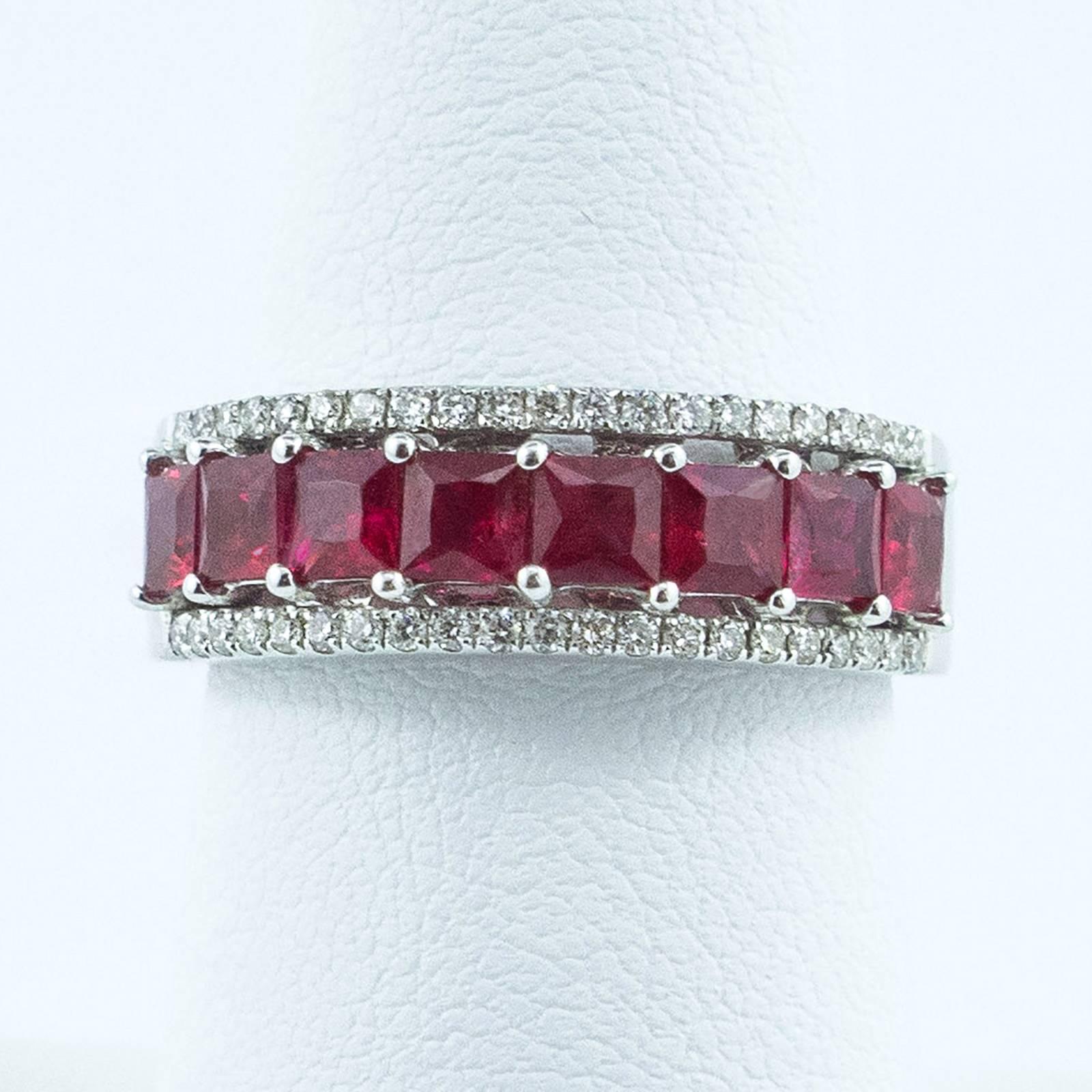 A striking half eternity band is centred with 8 Princess Cut natural Red Rubies totaling 1.81 carat with petite guards of clear, prong set Diamonds totaling 0.23 carat by gauge and formula.

The top of the ring measures 8mm north to south on the