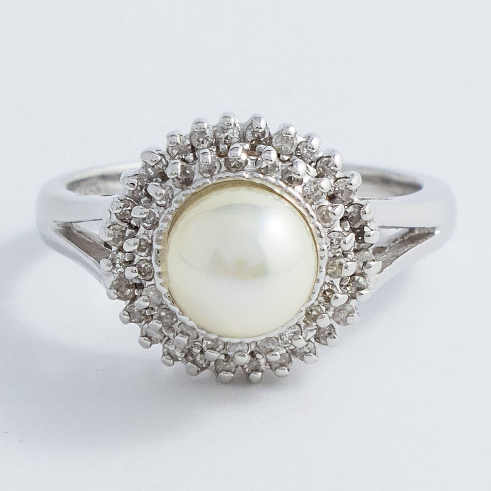 A lovely Akoya Pearl and Diamond White Gold Ring. This Japanese Akoya Cultured Pearl is encircled in two stepped rows holding 61 small, Brilliant Cut Diamonds, set in a 14K Gold split shank.

The top of the ring measures approximately 15mm, rising