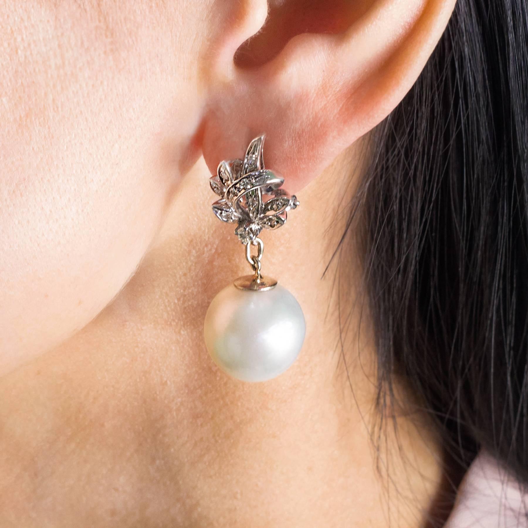 A stunning pair of South Sea Pearl Diamond White Gold Convertible Drop Earrings. Silvery White South Sea Pearls, measuring 15-15.5mm, are suspended from detachable 18K  white gold stylized leaves inset with fiery white Diamonds. Beautiful when worn