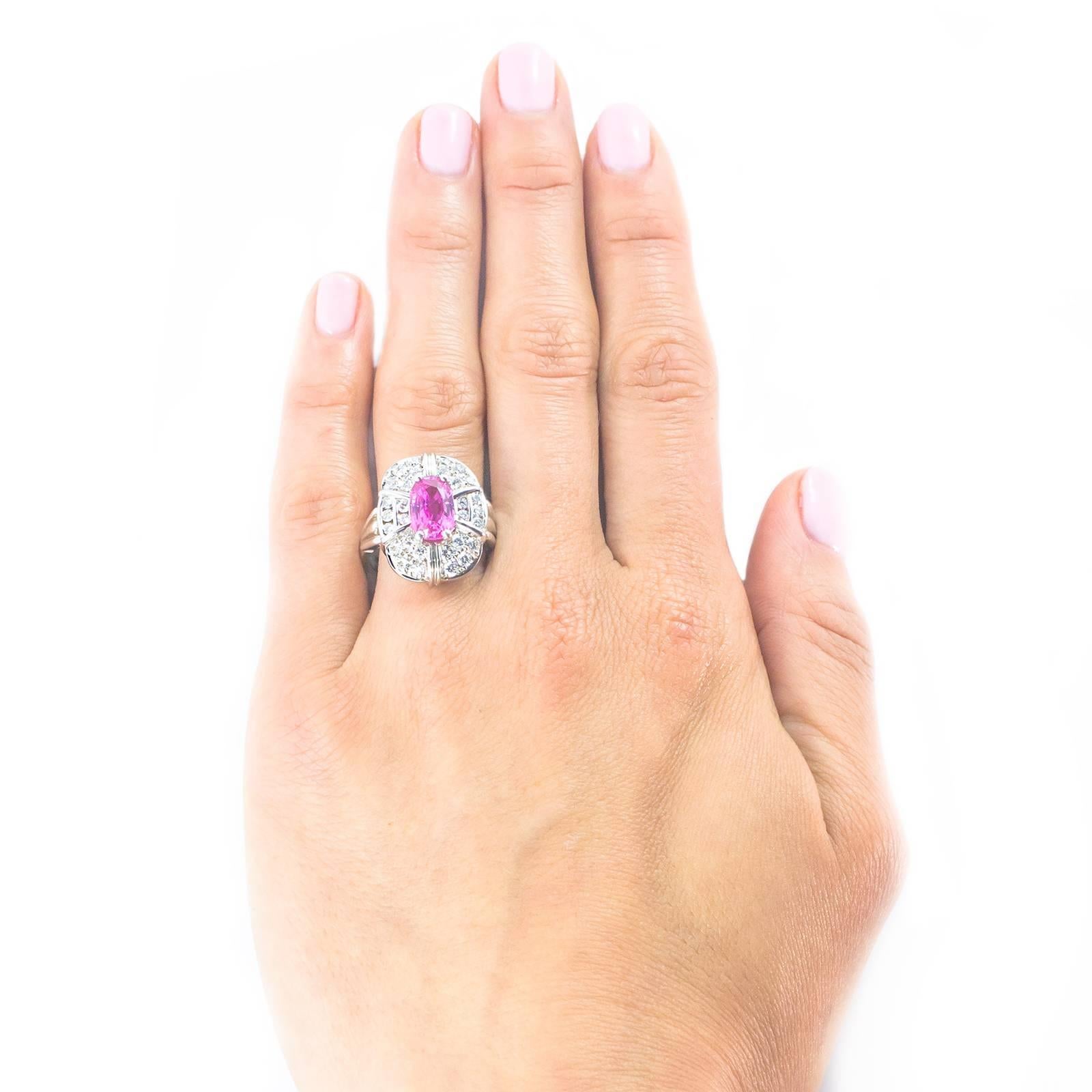 In this splendid Pink Sapphire Diamond White Gold Ring, a stunning Pink Sapphire is set within a surround of 30 White Diamonds in this refined, elegant 14K white gold mount.

The ring is very finger flattering sitting 15mm north to south covering