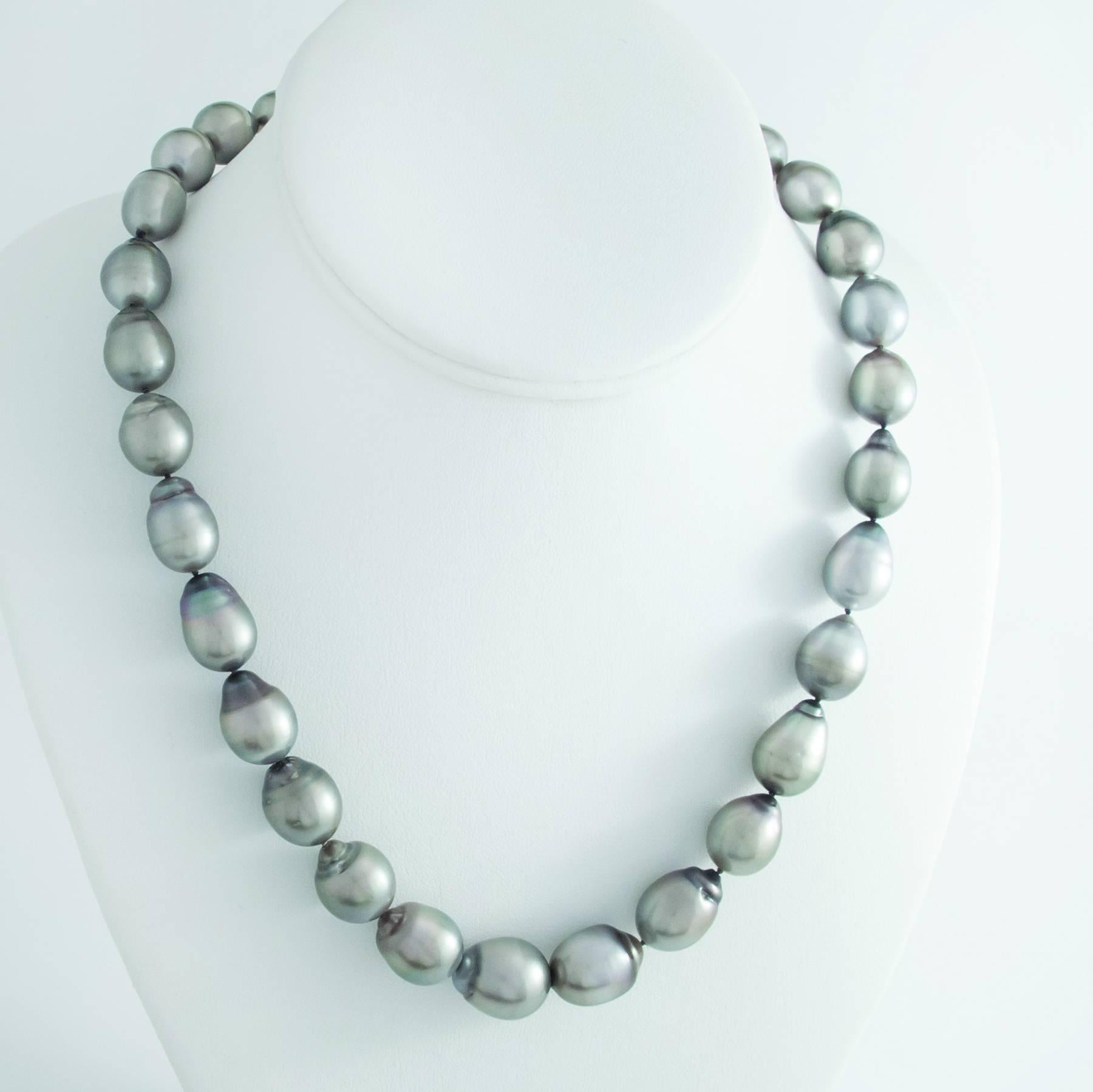 This lovely strand of oval shaped 10mm -14.5mm Tahitian Baroque Pearls measures 18 inches long and closes with a large 18K Gold clasp.

The Pearls are large and impressive. Slightly graduated with a thick nacre, and beautiful bright orient and