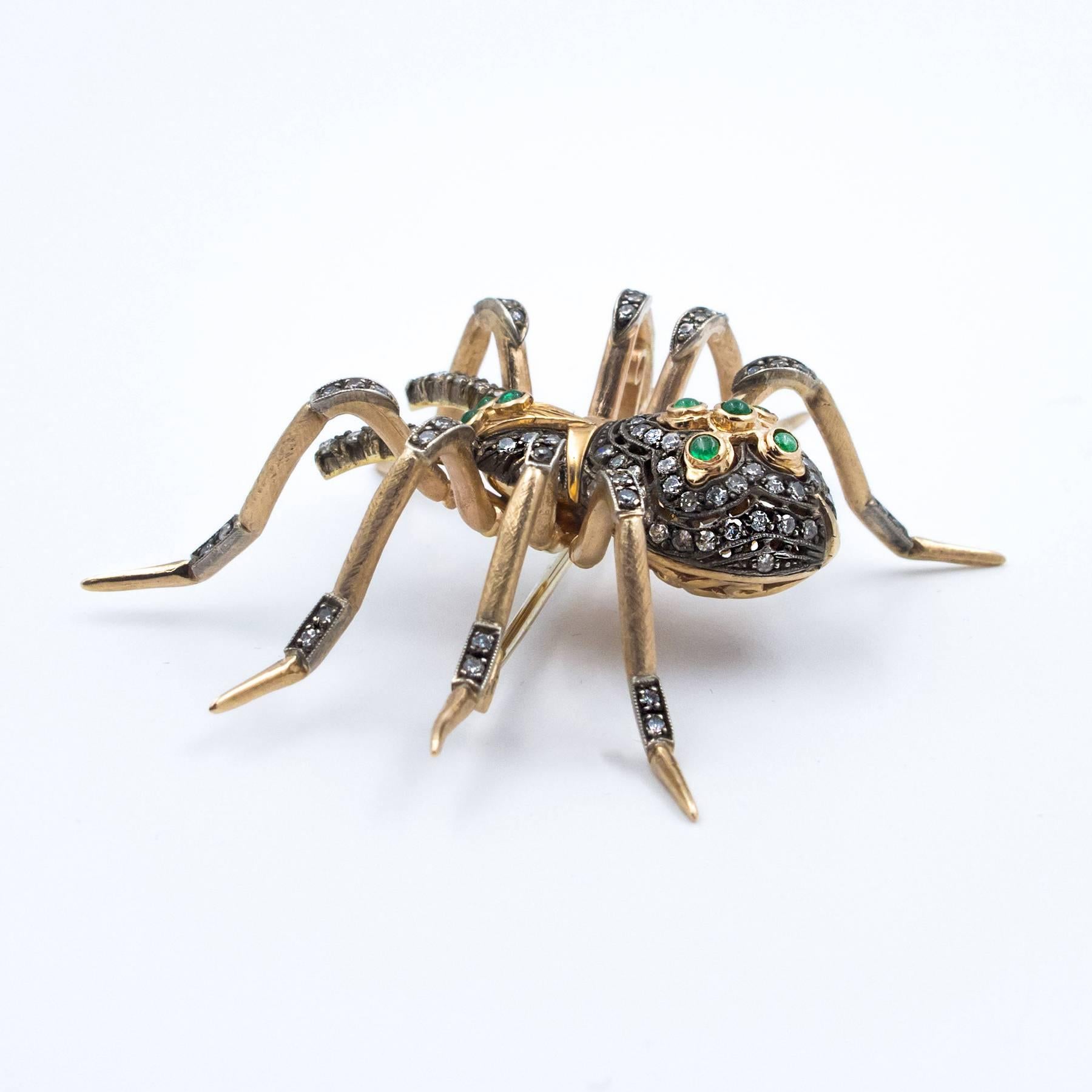 A handcrafted Diamond and Emerald Brooch in the form of a Spider. Set with 179 Diamonds and Emeralds in 14 Karat Pink/Yellow hand rubbed and textured gold.

Beautifully detailed, this is a large and impressive pin, remaining very wearable at 2.50