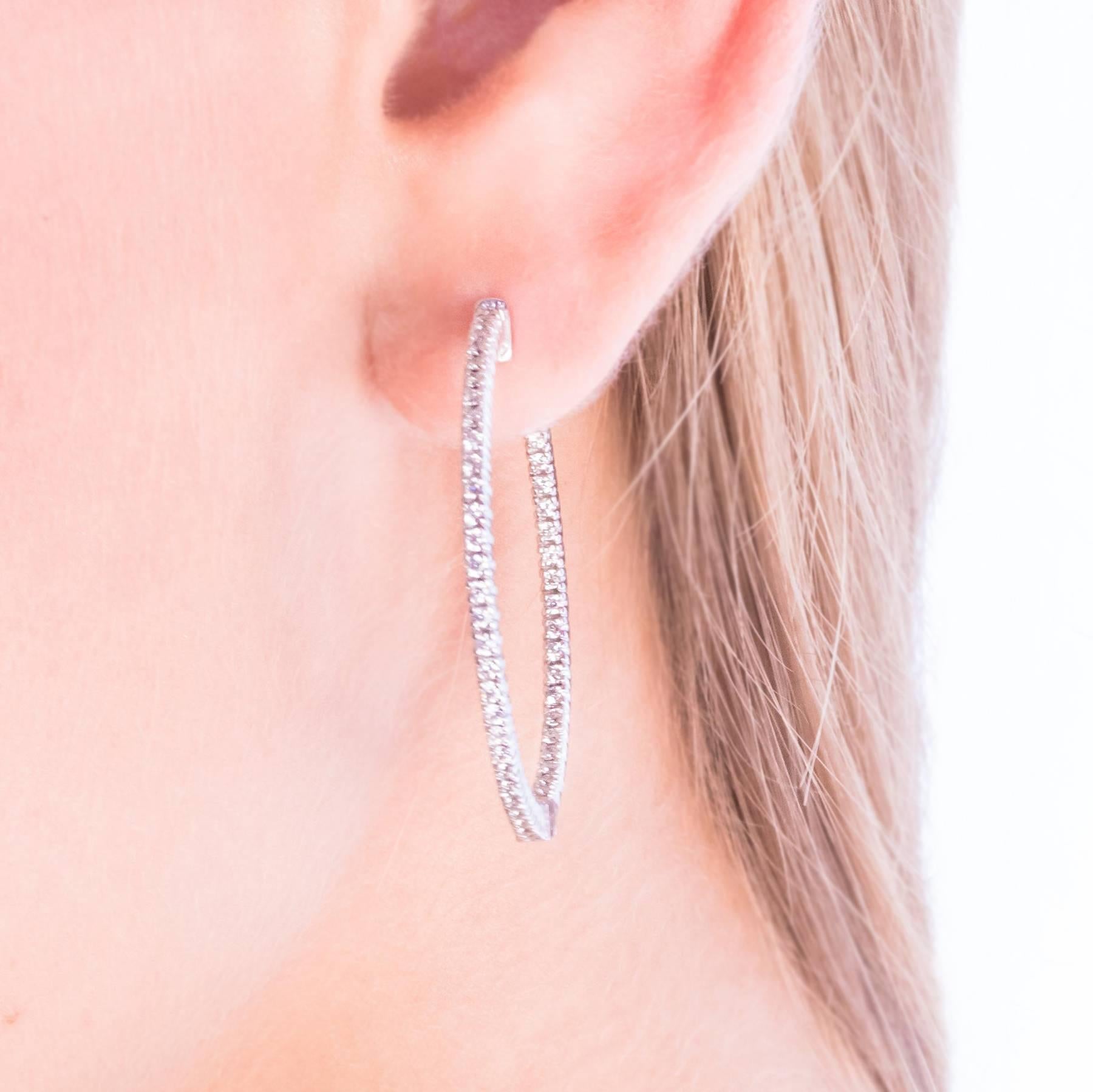 A beautiful pair of Diamond Hoop Earrings are set with Diamonds to the outer front half and inner back half in White Gold. These are beautifully crafted and sturdy, Hoops that are fully hinged and will not warp.

There are 100 Round, Brilliant Cut