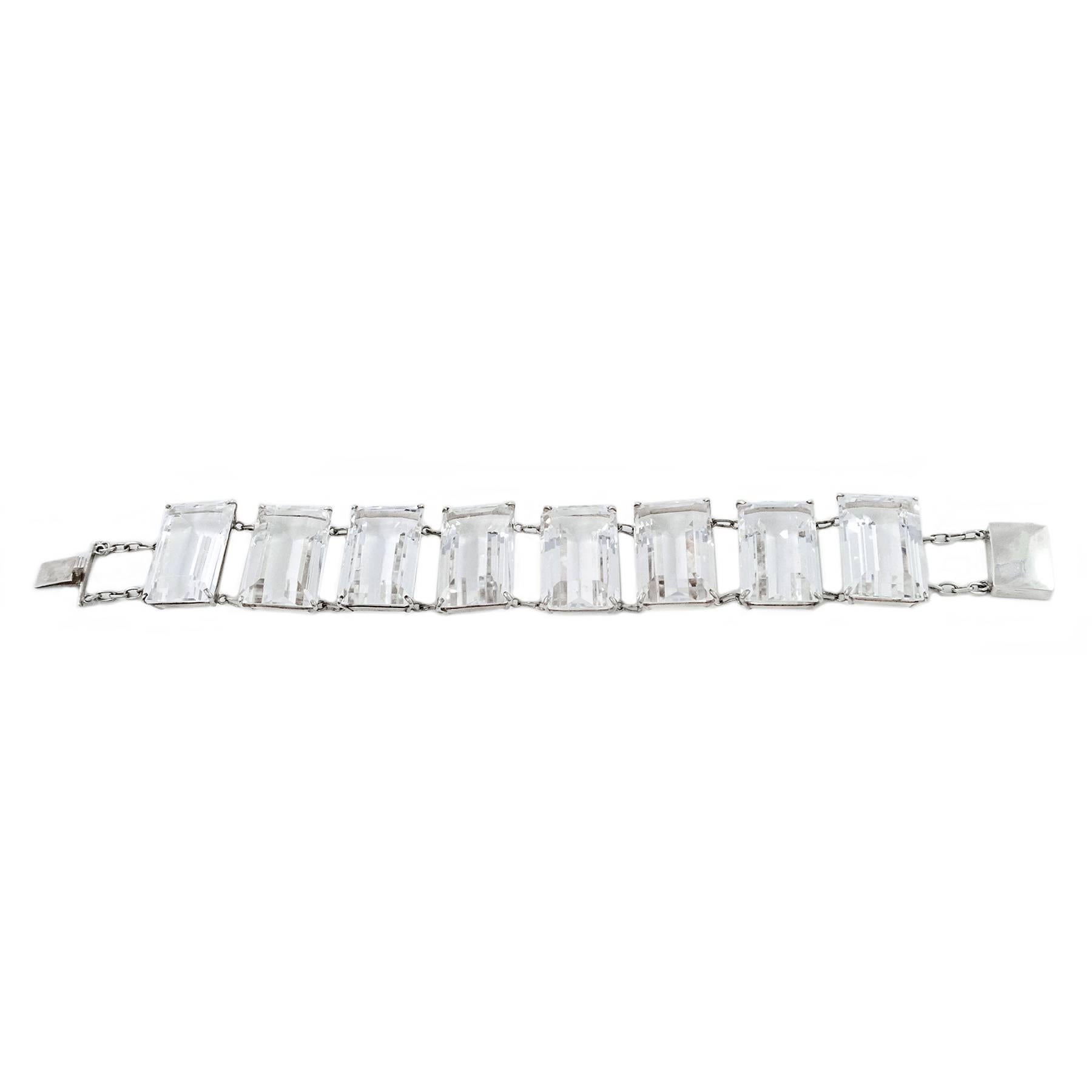 There are eight Emerald Cut clear Rock Crystal Quartz gemstones, totaling 235.13 carats, set in this beautiful bracelet.

The hand cut and faceted stones measure  24mm x 15mm x 9.90mm by gauge and formula, claw set in sterling silver mounts that are