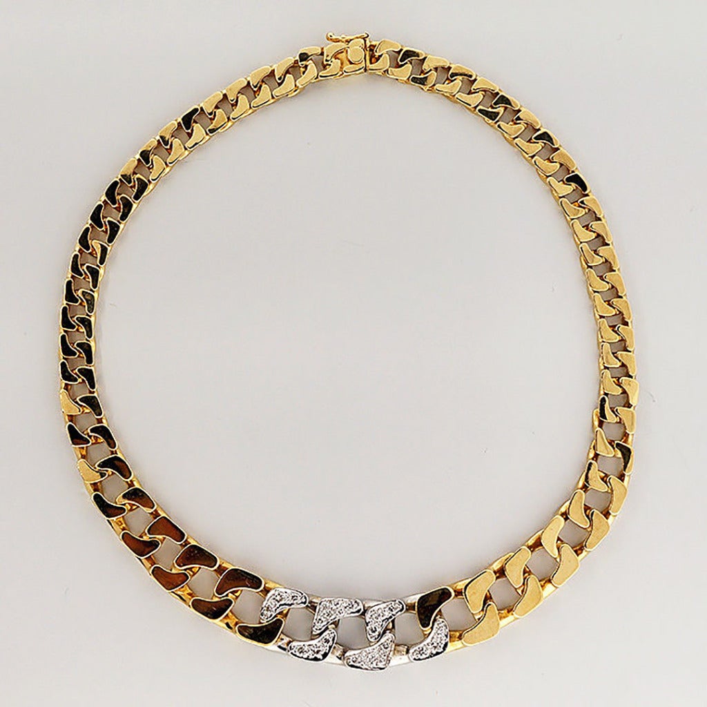 Solid heavy 18k flat top graduated curb link necklace. Well-polished with rich deep yellow gold.  The 3 center links are bright white gold and are pave set with bright sparkly diamonds.  Hidden catch with side locking safety.  This lays perfectly on