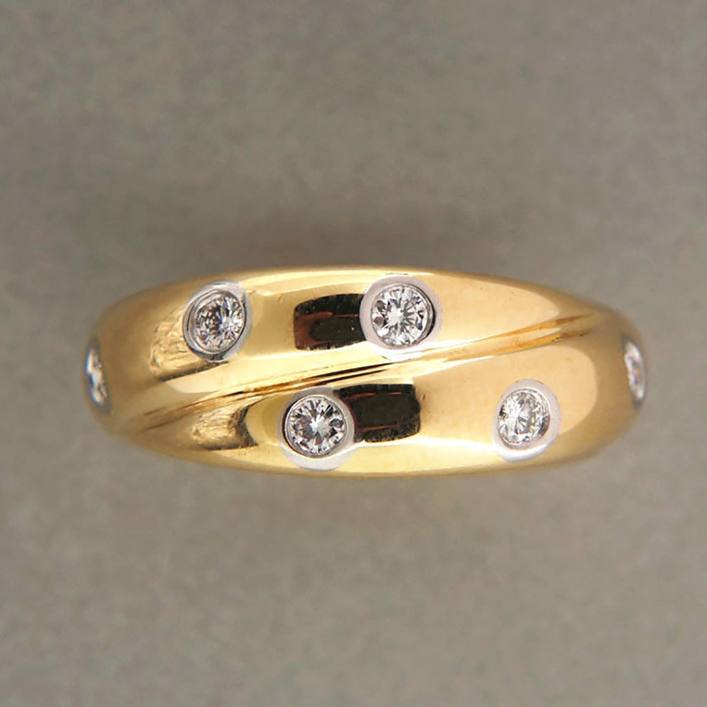 Authentic Tiffany & Co Etoile crossover band

12 full cut diamonds, approx. total weight .30cts, F-G, VS
Stamped: Tiffany + Co Pt 950 750
7.3 grams
Width: 7.1mm
Size 5 1/4 and not sizable