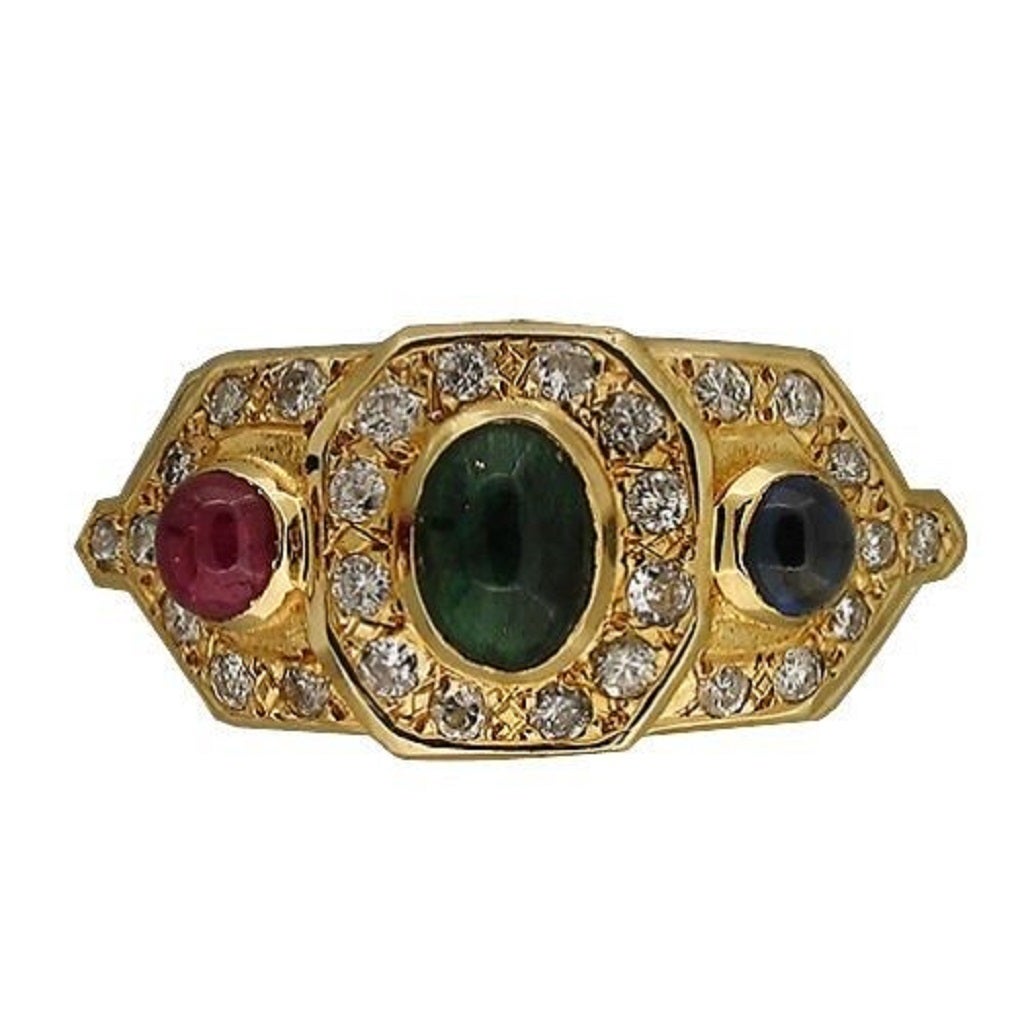 Byzantine style 14k yellow gold ring set with 3 top quality genuine cabochon stones. An emerald is in the center with a ruby and sapphire on either side. All 3 stones are surrounded by good quality bead set diamonds.

1 oval cabochon emerald