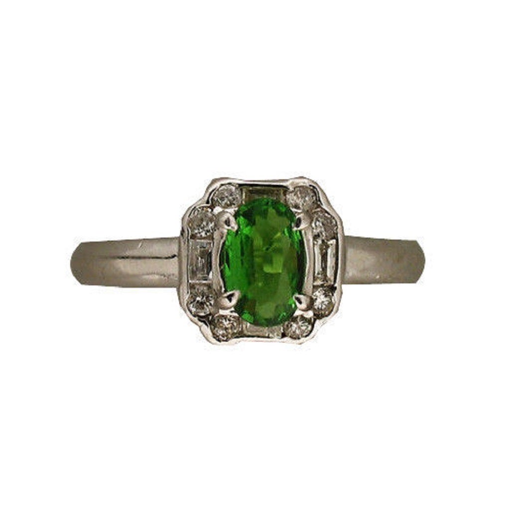 Handmade solid Platinum Art Deco style ring circa 1940.  Set with good quality bright sparkly round and baguette diamonds. The center is set with a vivid green genuine Tsavorite Garnet, as bright as any we have seen.

1 oval Tsavorite Garnet
