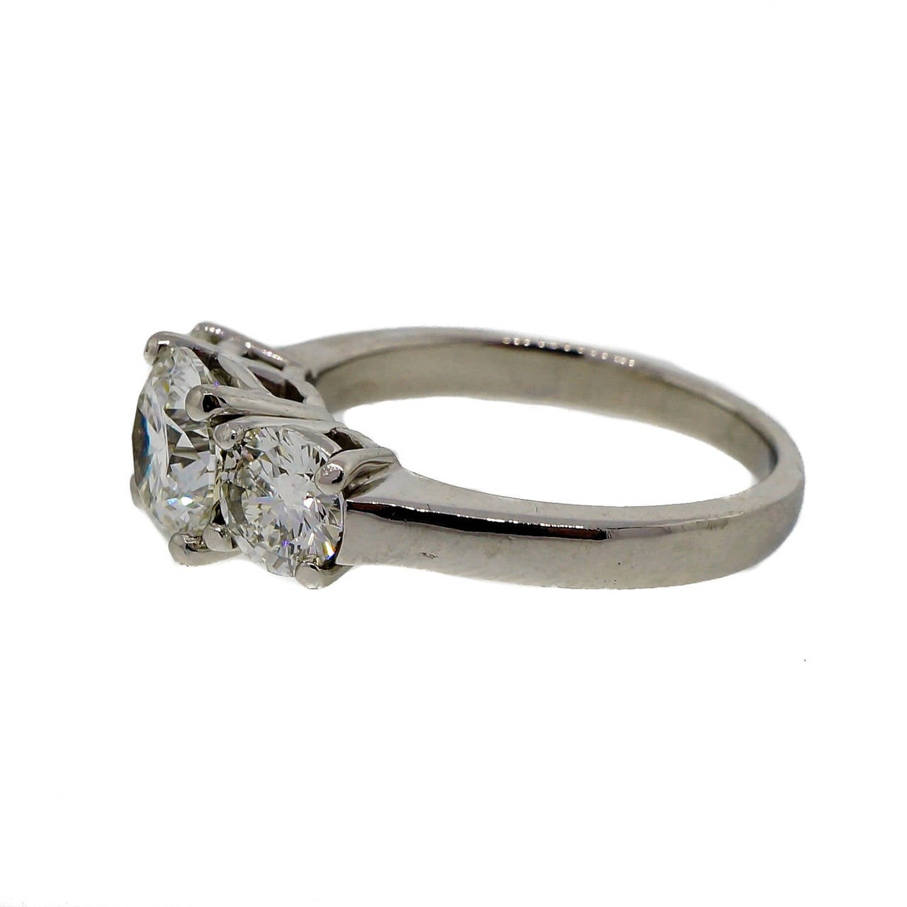 Classic solid Platinum set low to the finger 3 stone diamond ring made with quality, not quantity, in mind. Bright sparkly G, VS2 diamonds. The diamonds are from an estate. The setting is from the Peter Suchy Workshop. PSD. 

1 round brilliant cut