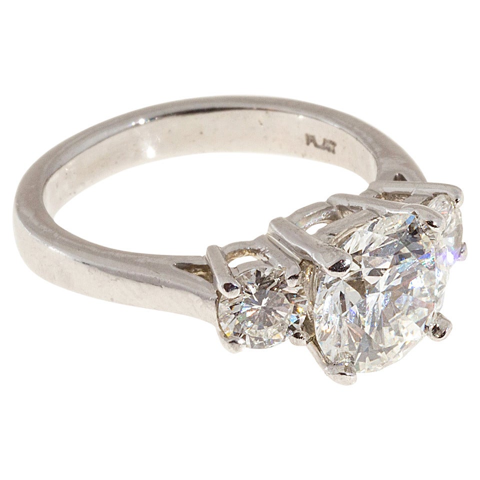 Peter Suchy classic 3 stone diamond engagement ring. handmade in the Peter Suchy Workshop. Platinum setting with 2 well cut side diamonds and an ideal cut GIA certified center diamond cut grade excellent, color H, Clarity SI2, . Small inclusions not