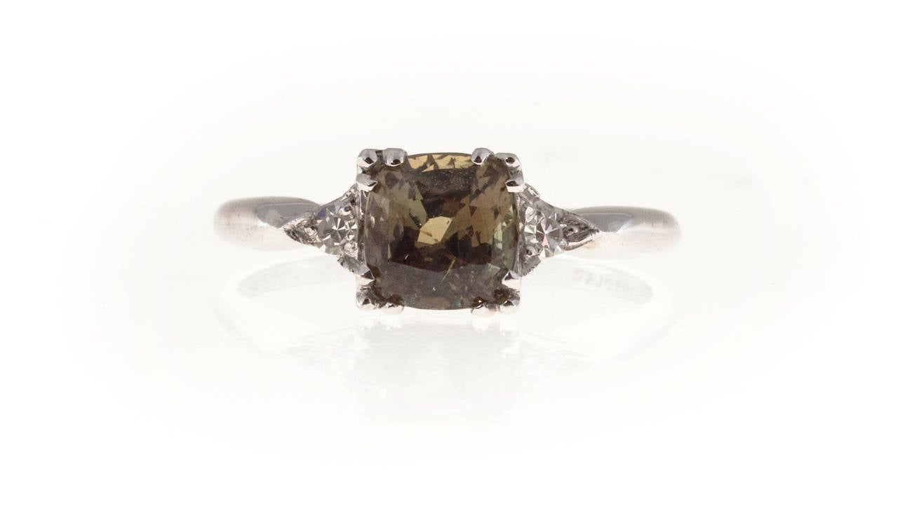 Platinum all original 1940's ring with original natural Alexandrite center.

1 Natural untreated cushion Alexandrite 6.35 x 6.20 x 4.4mm, approx. total weight 1.48cts, yellowish green changing to brown orange. GIA certificate# 5151002739
2 round