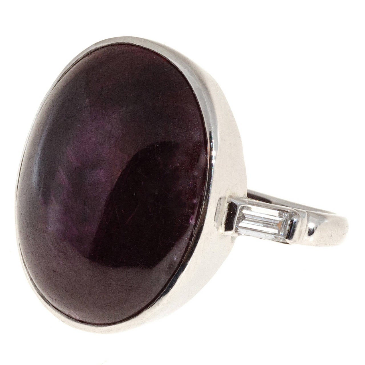 Platinum bezel set oval cabochon ruby and diamond cocktail ring. Handmade baguette side diamond setting, with a large all natural no heat no enhancement 17.90ct dark purplish red Ruby center. 

17.90ct natural no heat Ruby cabochon dark purplish red