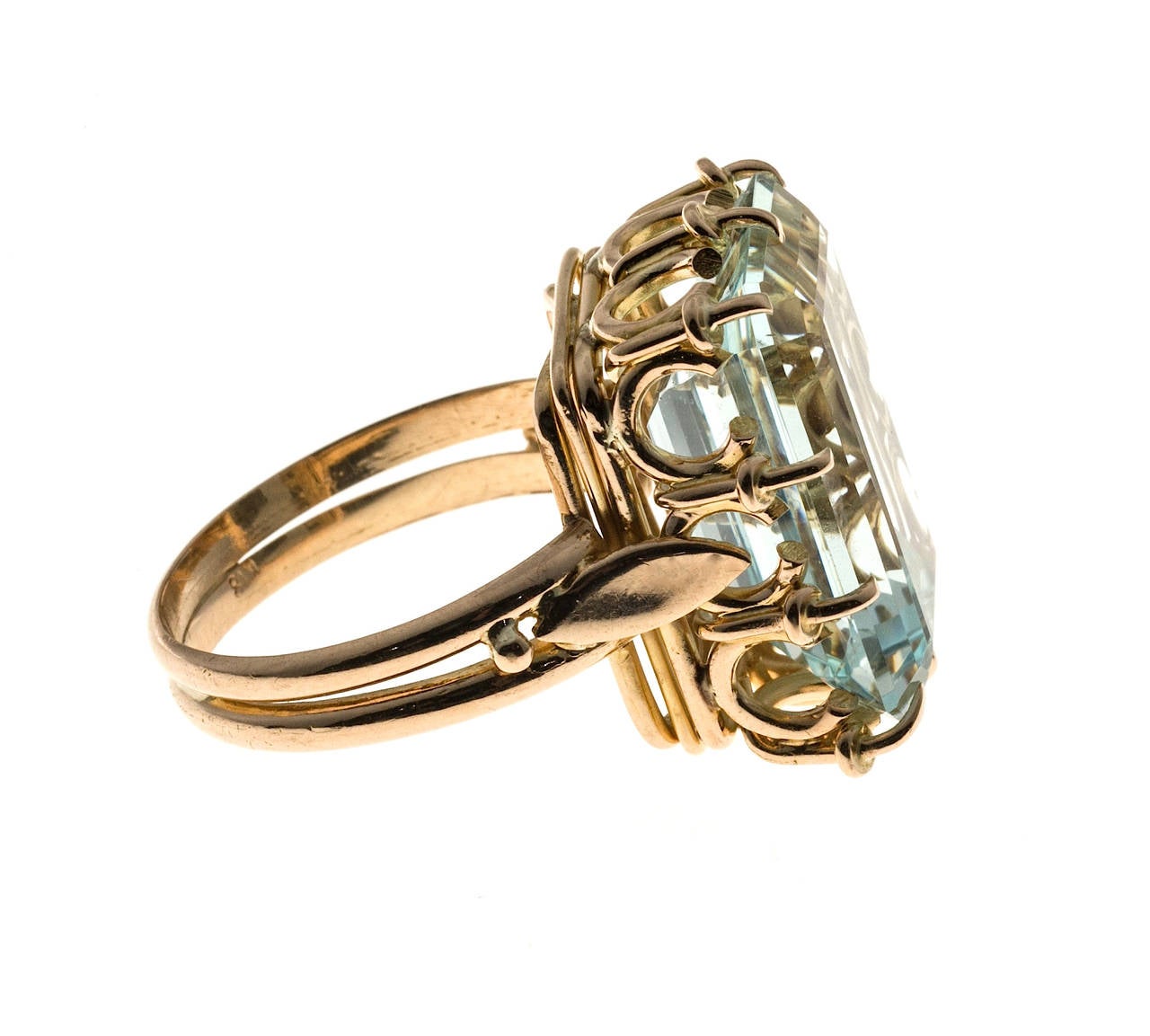 1940 Totally handmade most likely European 18k yellow gold crown style ring set with a natural no heat untreated Aqua. Excellent color and brilliance.

1 Emerald step cut 13.56mm x 12.92mm slightly greenish blue natural no heat Approx. 13.17cts