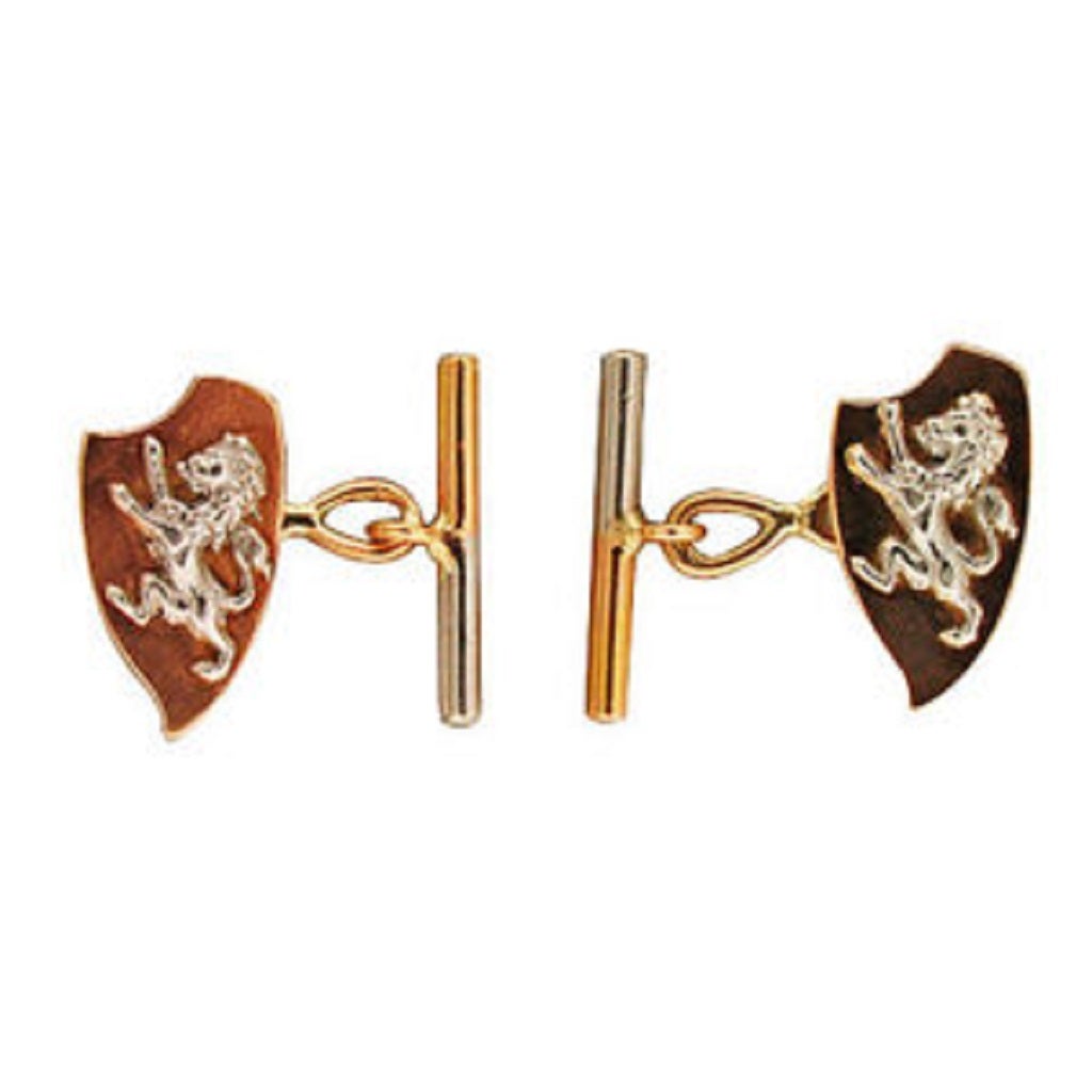 14k Rose gold and platinum cuff links. A raised solid Platinum lion sits on top of the shield. The connector is 14k rose gold. The bar on the back is half platinum and half rose gold. The cuff links have a natural patina.  Circa 1920-1930.

14k
