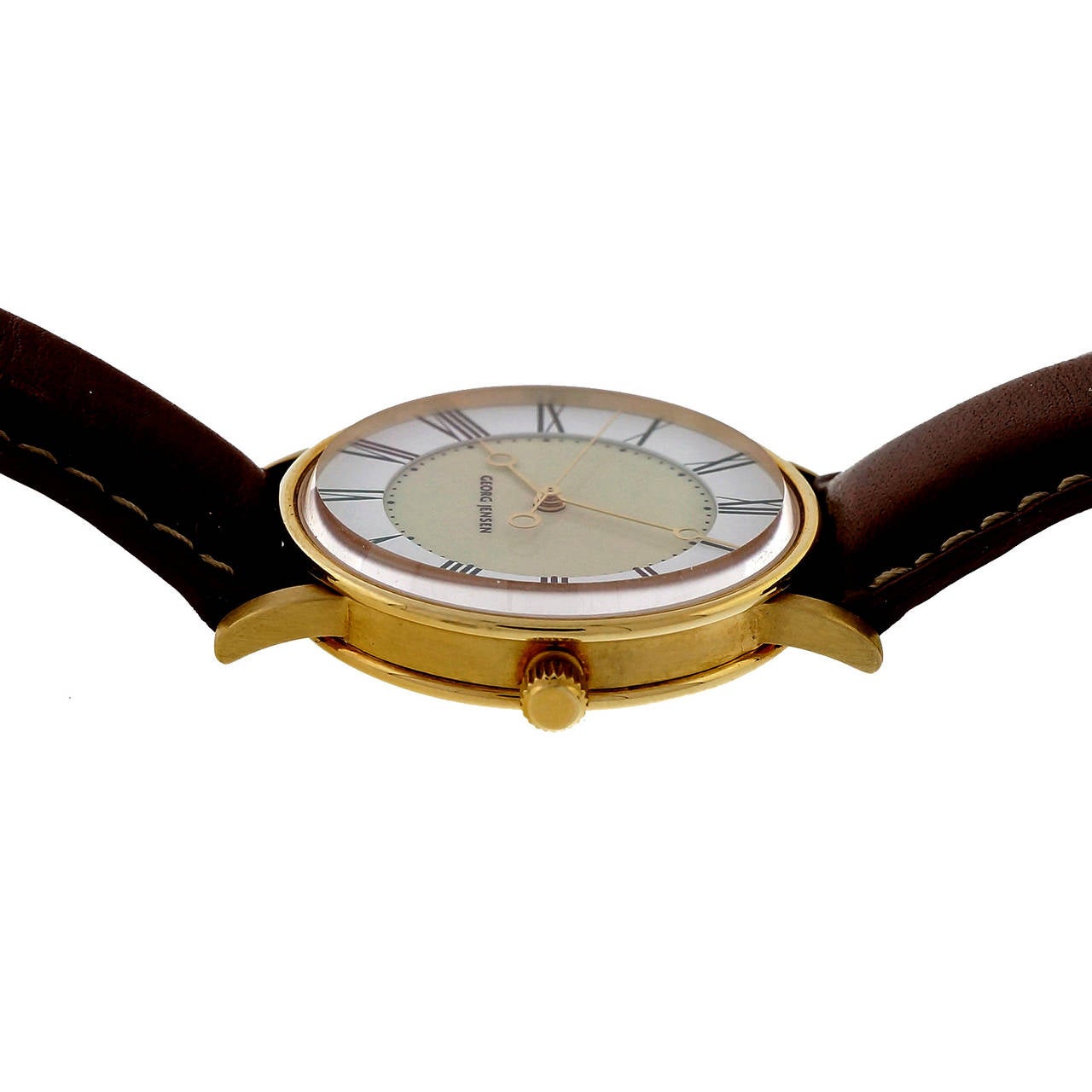 Two tone Georg Jensen self-wind classic wrist watch in solid 18k yellow gold.

52.6 grams
18k yellow gold
Width without crown: 34.37mm
Width with crown: 36.99mm
Band width at case: 19mm
Case thickness: 9.24mm
Band: Original Georg Jensen –