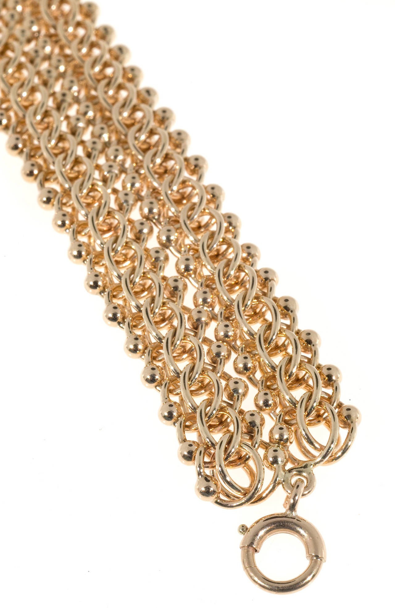 Flexible solid 14k bracelet, just over 3/4 inch wide. This highly unusual bracelet is made from 2 rows of beaded double spiral link chain soldered together. The gold color is slightly rose tinted. On Peter's now famous pink gold scale of 1 to 10