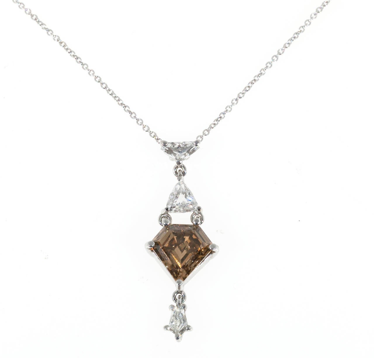 One of a kind handmade pendant with 3 uniquely shaped white diamonds.  Shield shape a natural genuine fancy orangey brown certified 1.63ct   diamond.  Near perfect cutting.  Certified as a modified kite step cut natural fancy orangey brown color