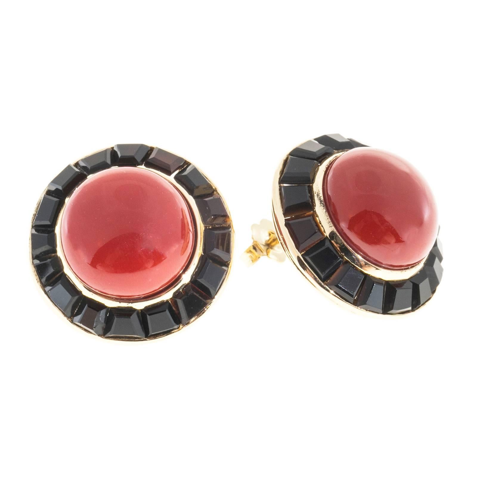 18k yellow gold gem quality red well-polished untreated Coral earrings circa 1950 to 1960 surrounded by custom trapezoid cut black Onyx.

2 round orangey red Coral, 13.41 x 13.43mm, natural color, no heat and no enhancements, GIA certificate