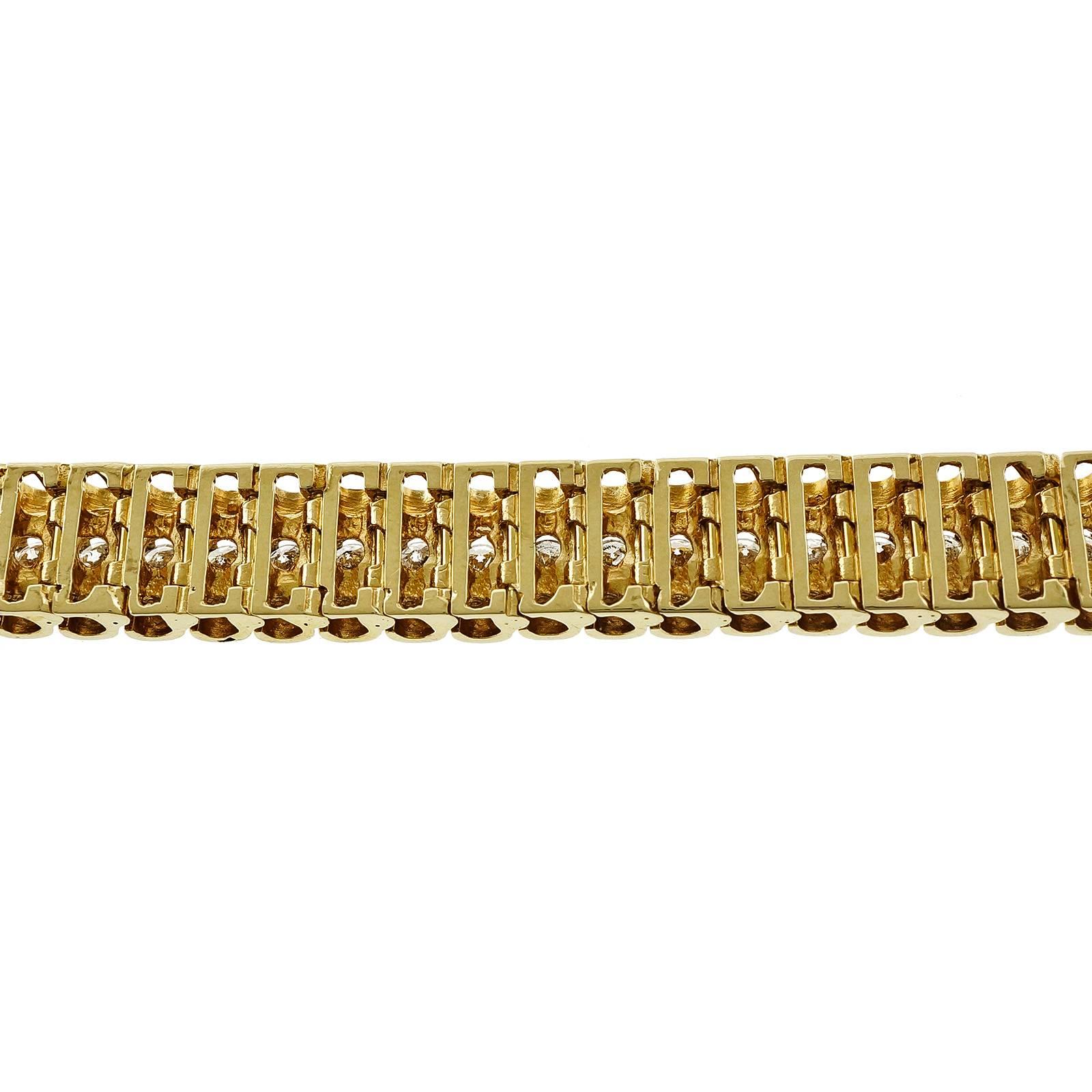 Cylinder link design bracelet in 14k yellow gold with a center strip of bright white diamonds in white gold prongs. Extra secure partially concealed lobster catch. Circa 1970.

52 round diamonds approx. total weight 2.60cts, H, SI1
14k Yellow