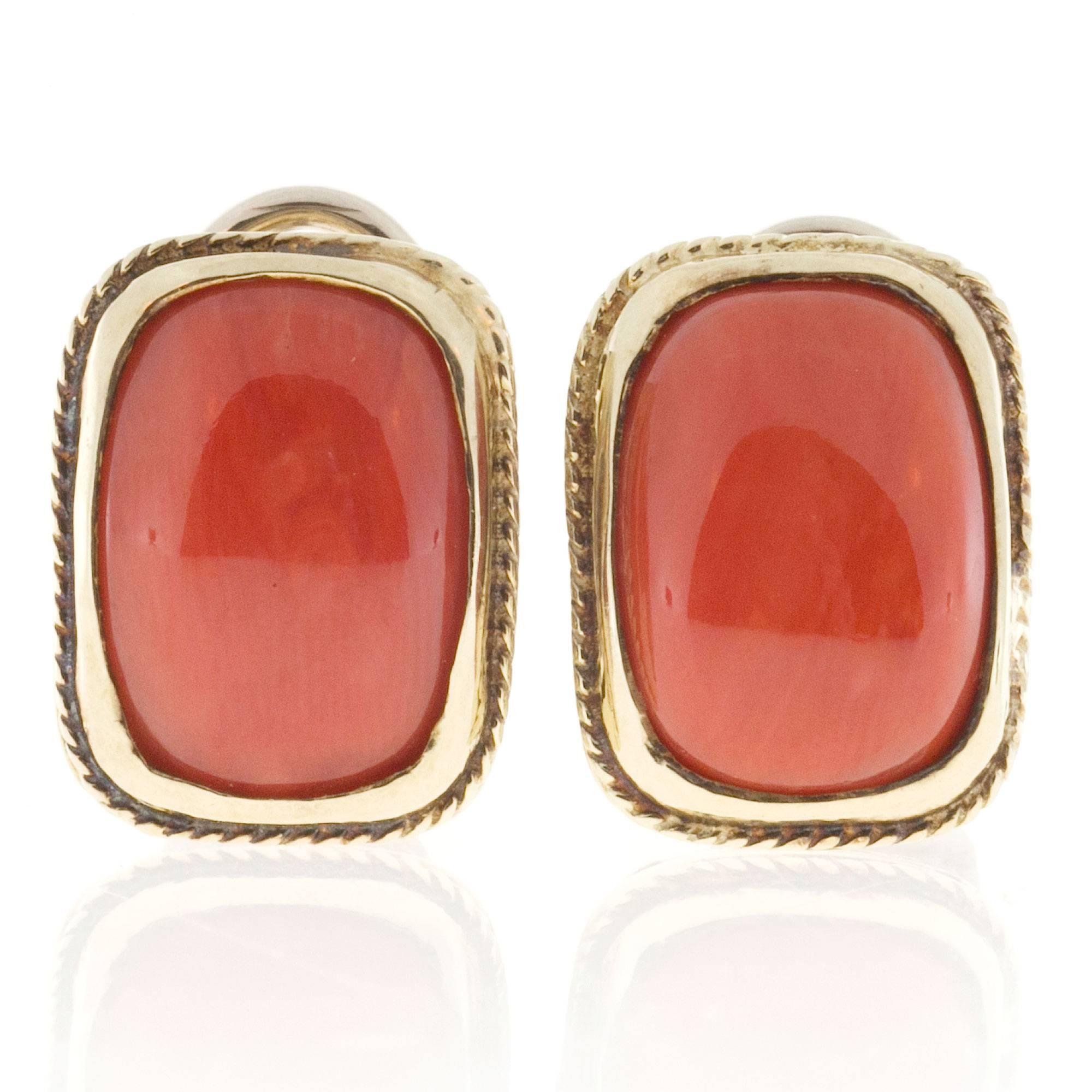 Top gem orange well-polished untreated Coral set in hand made clip post earrings with pierced galleries.  Pierced side gallery and under gallery.

2 Natural orange Coral untreated 13.3 x 9.5mm
14k Yellow Gold
Stamped: 14k Italy
10.4
