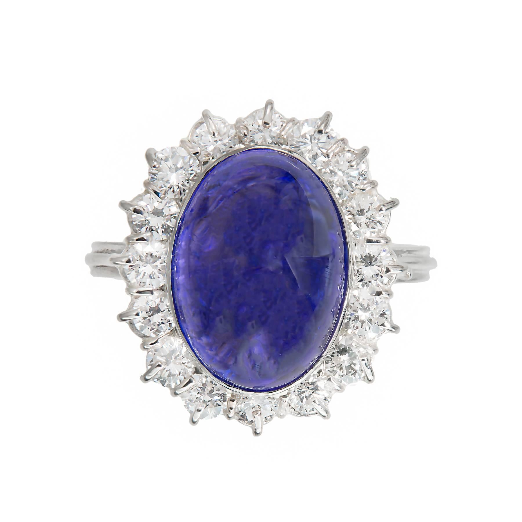 Oval Cabochon Tanzanite halo engagement ring. 9.75ct oval center stone with a halo of 16 round diamonds in a 14k white gold original 1970's setting. There are moderate inclusions some of which are eye visible especially from the side.

One-gem