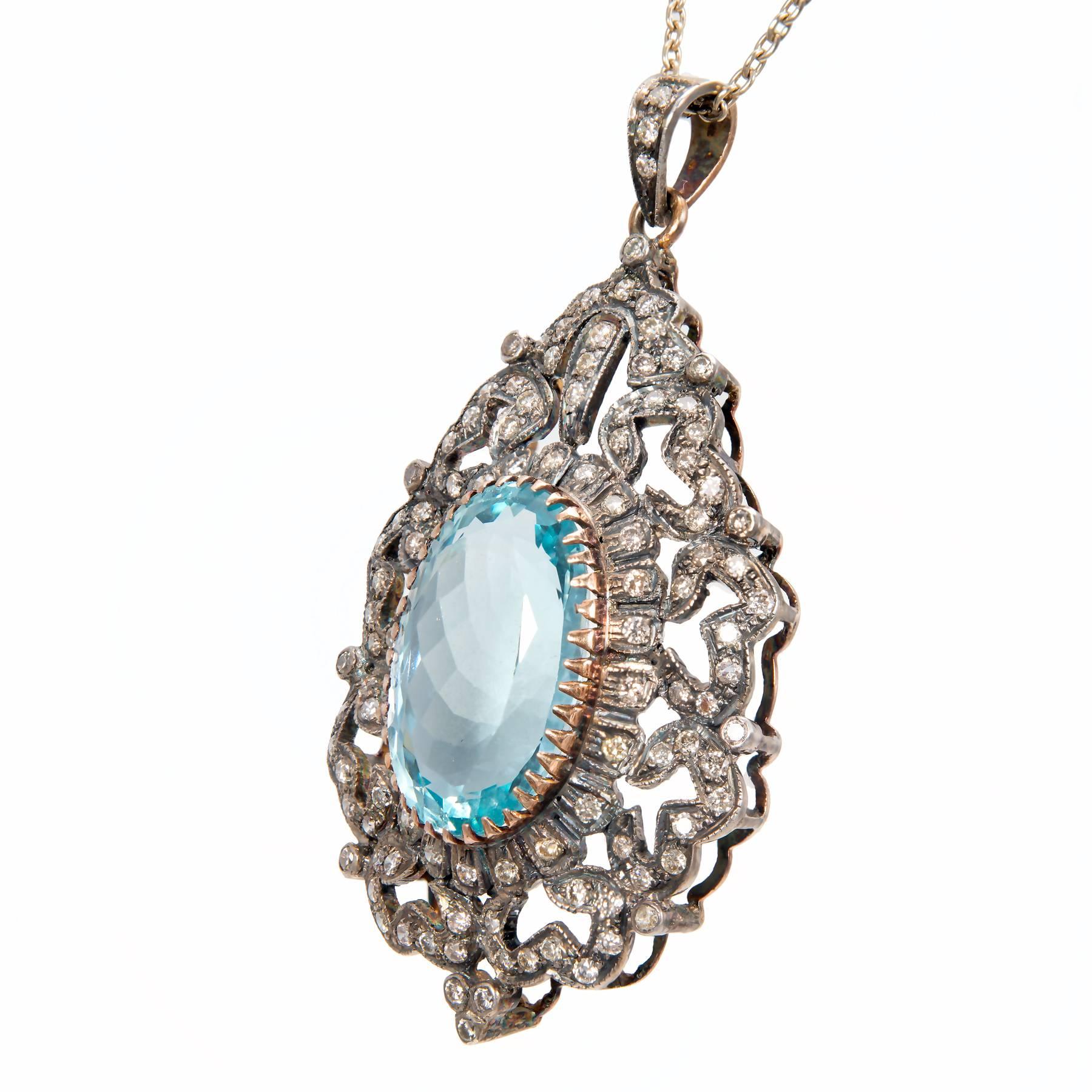 Handmade silver top 14k yellow gold backed pendant. 18k yellow gold bezel. Genuine medium blue Aquamarine in an open work pendant with 116 round accent diamonds. 18k white gold chain all with natural patina. 

1 oval Aquamarine, approx. total weight