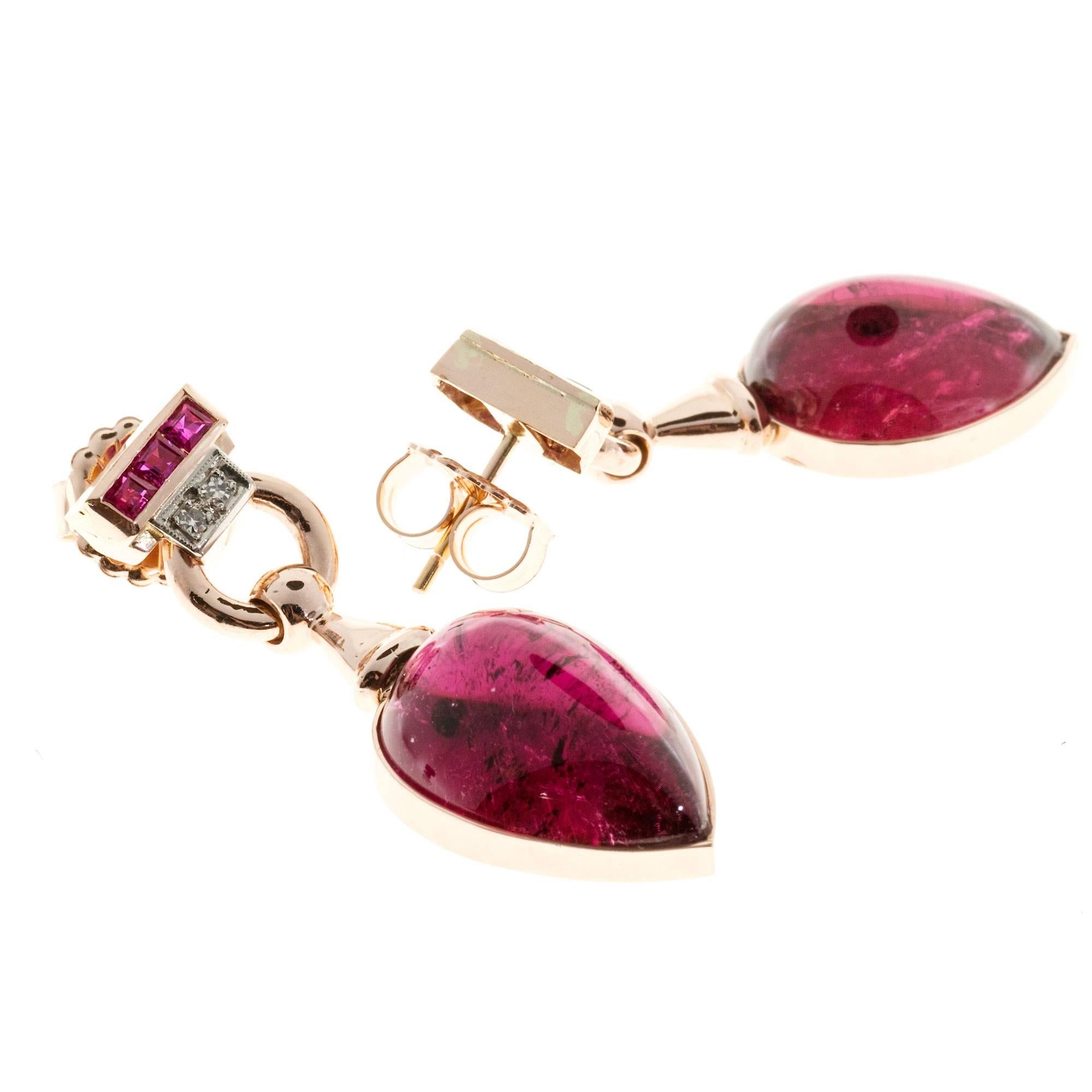 14k pink gold flexible dangle earrings with bright pink red genuine Ruby tops, diamond accents and red Tourmaline (Rubellite). Cabochon bottoms. Large size safety, Friction backs.

2 pear cabochon bright red Tourmaline, approx. total weight