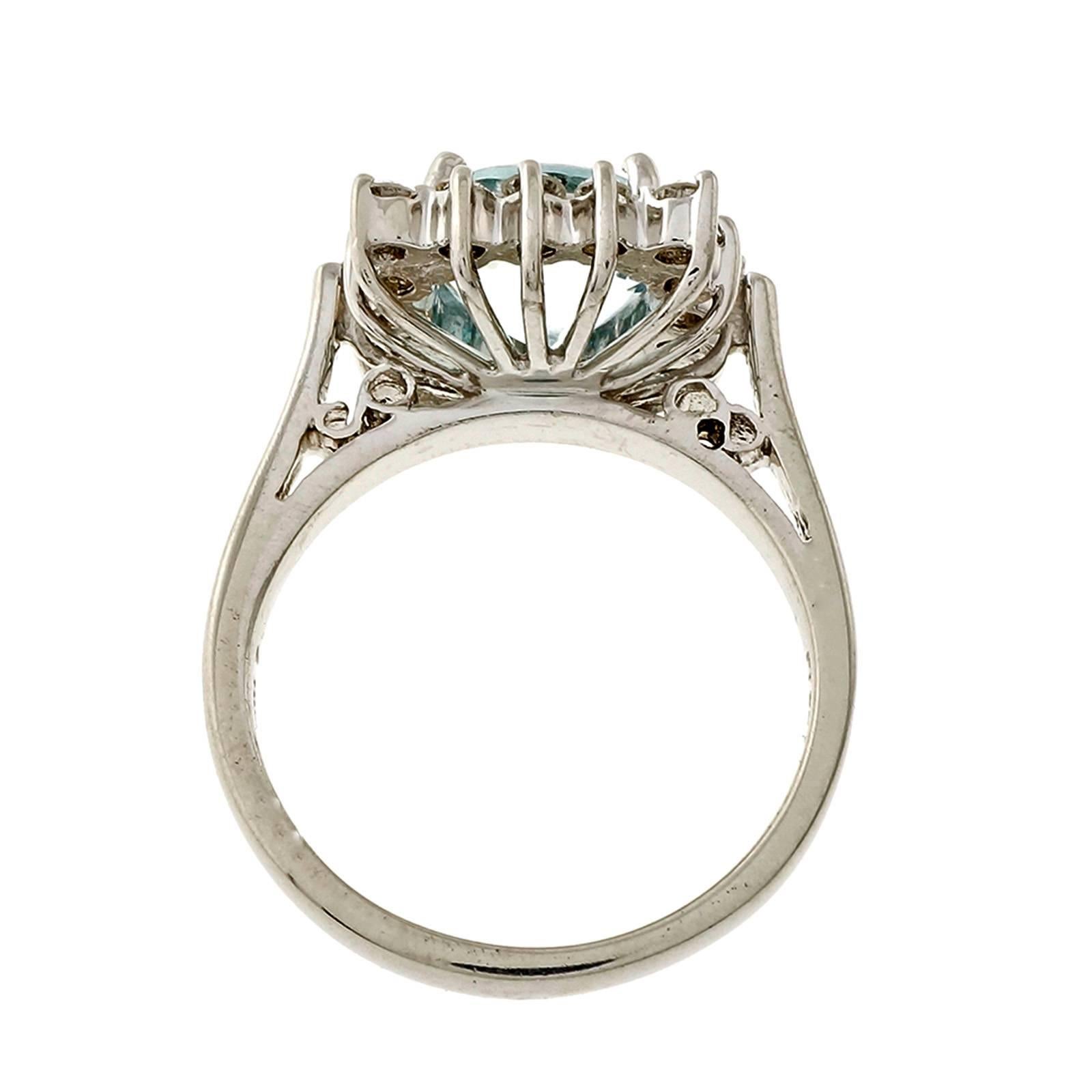 1960’s handmade wire square cocktail ring with a fine natural round Aqua in diamond halo.

1 fine untreated natural slightly greenish blue extra bright European cut Aquamarine, approx. total weight 2.53cts, VS, 9mm
16 round brilliant cut diamonds