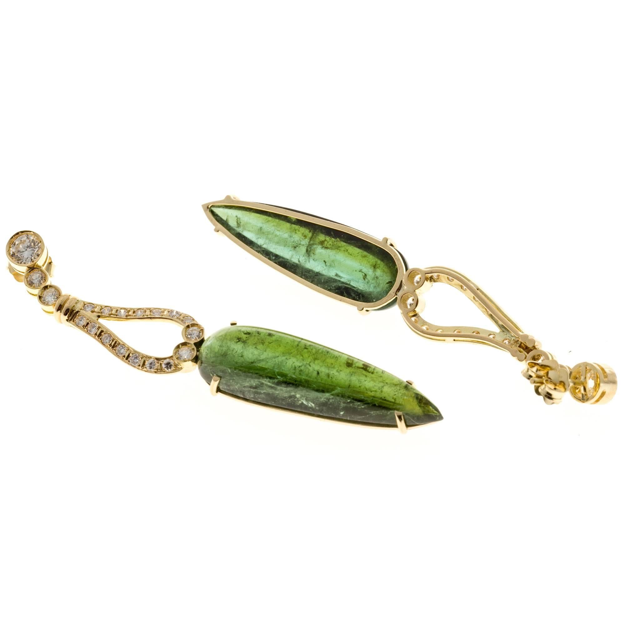 Vintage 1960 cabochon Tourmaline dangle earrings in 18k yellow gold with bright sparkly diamonds.  2.5 inches long.

2 cabochon green pear shaped natural Tourmaline, approx. total weight 32.65cts, moderate inclusions
2 round diamonds, approx.