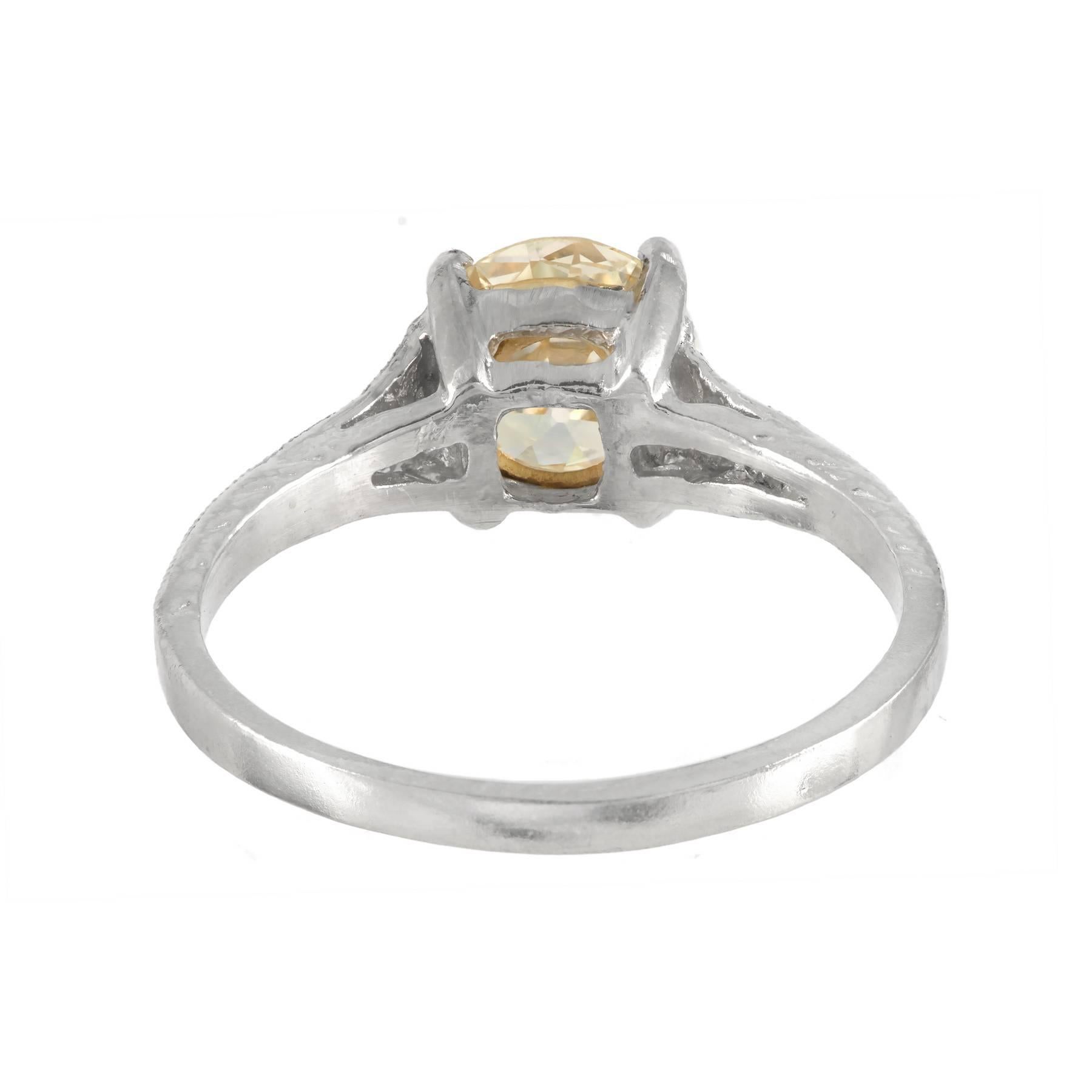 Very light yellow GIA certified diamond engagement ring in its original Platinum setting with old European cut diamond, and side accent diamonds. Circa 1920 -1930.

1 old European cut very light yellow diamond, approx. total weight .92cts, N, VS1,