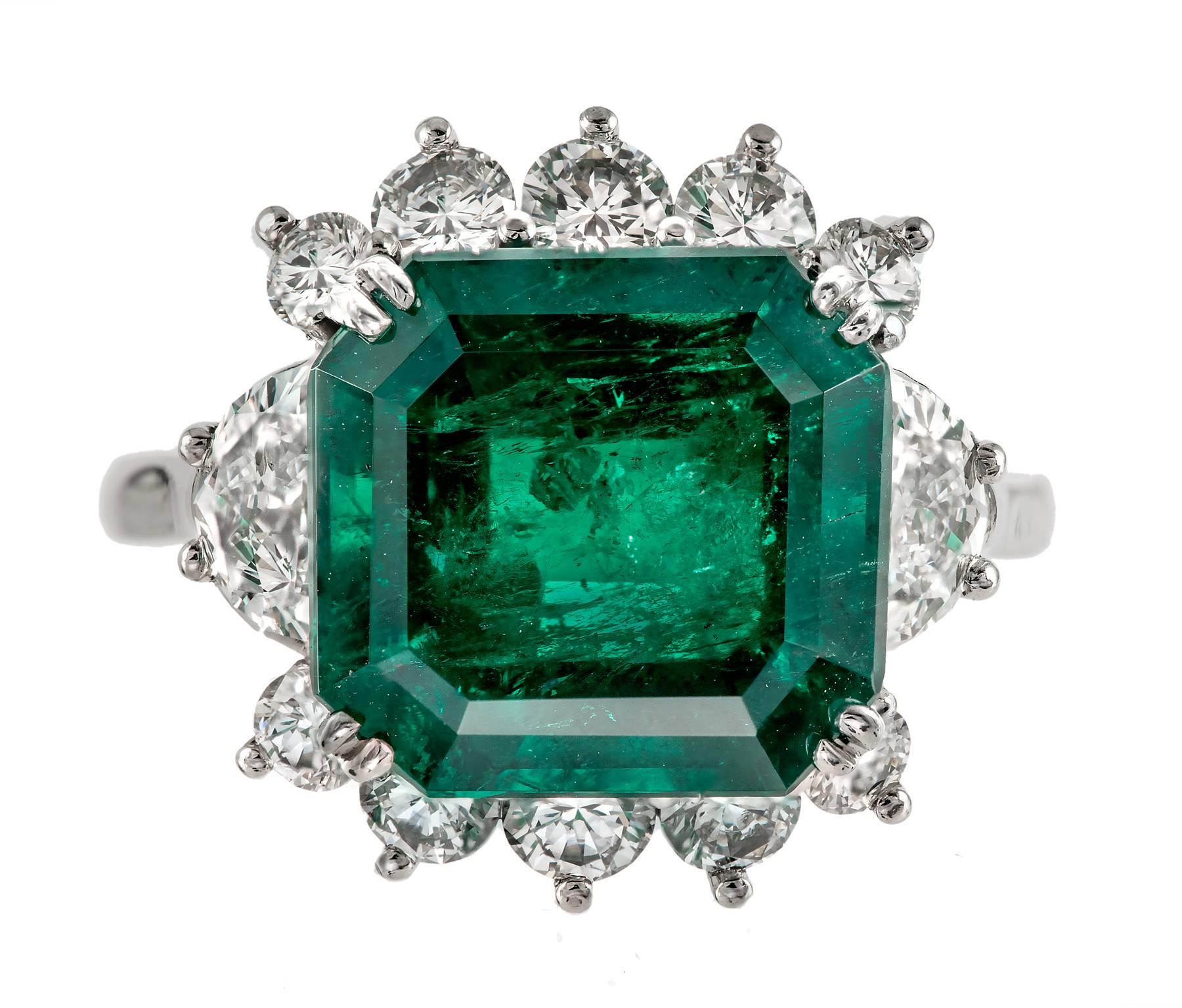 Fine deep green Colombian Emerald in a handmade platinum engagement ring with fine half-moon diamonds. Unusual and bright square eight sided step cut. GIA and AGL certified. Moderate clarity enhancement F2. Moderate natural inclusions. 

One emerald