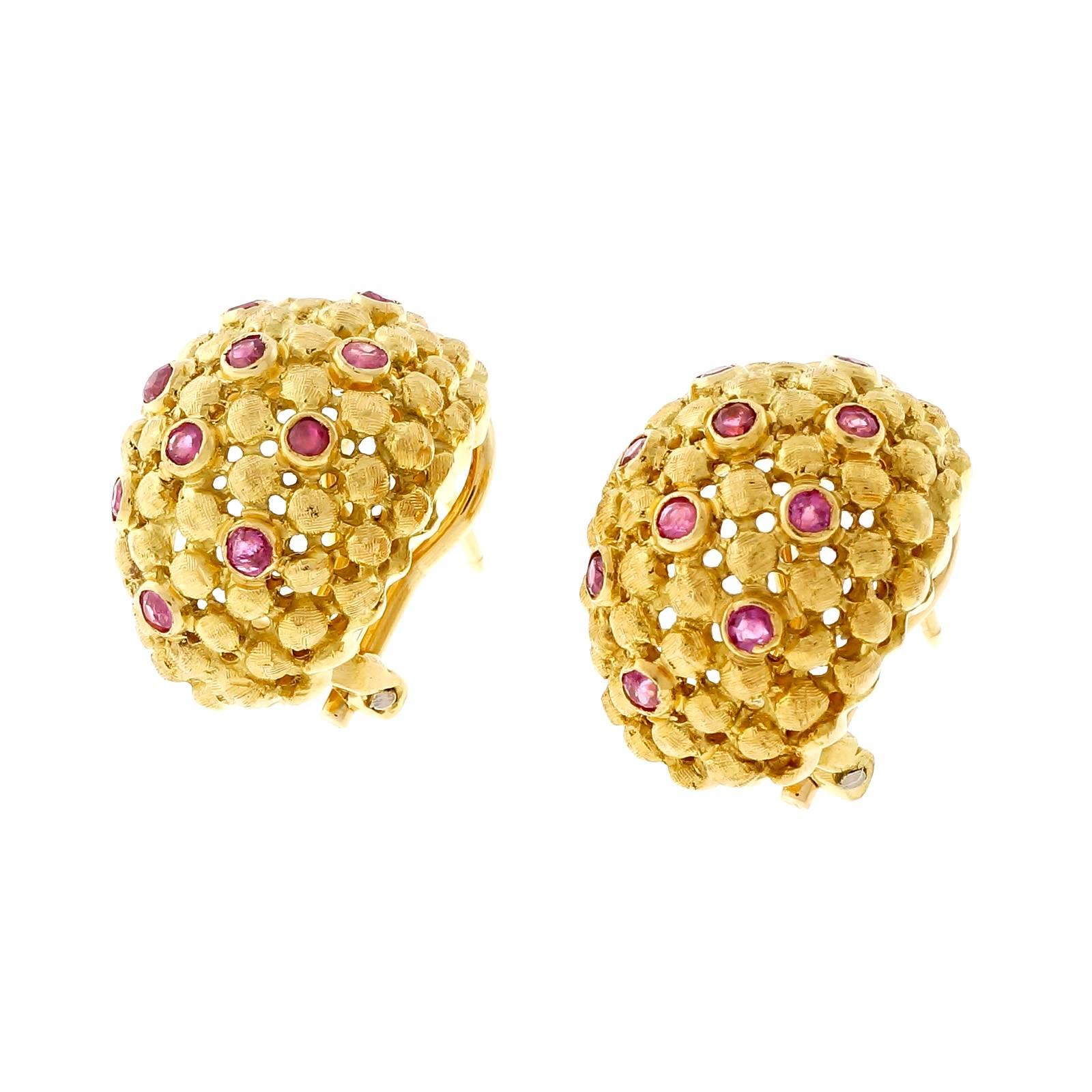 Spitzer & Furman Ruby 18k yellow gold clip post earrings. Domed textured open work design with 29 round rubies. 

29 round Rubies, approx. total weight .70cts
18k yellow gold
14.1 grams
Tested: 18k
Stamped: K 18
Hallmark: S&F Italy 378
Top to