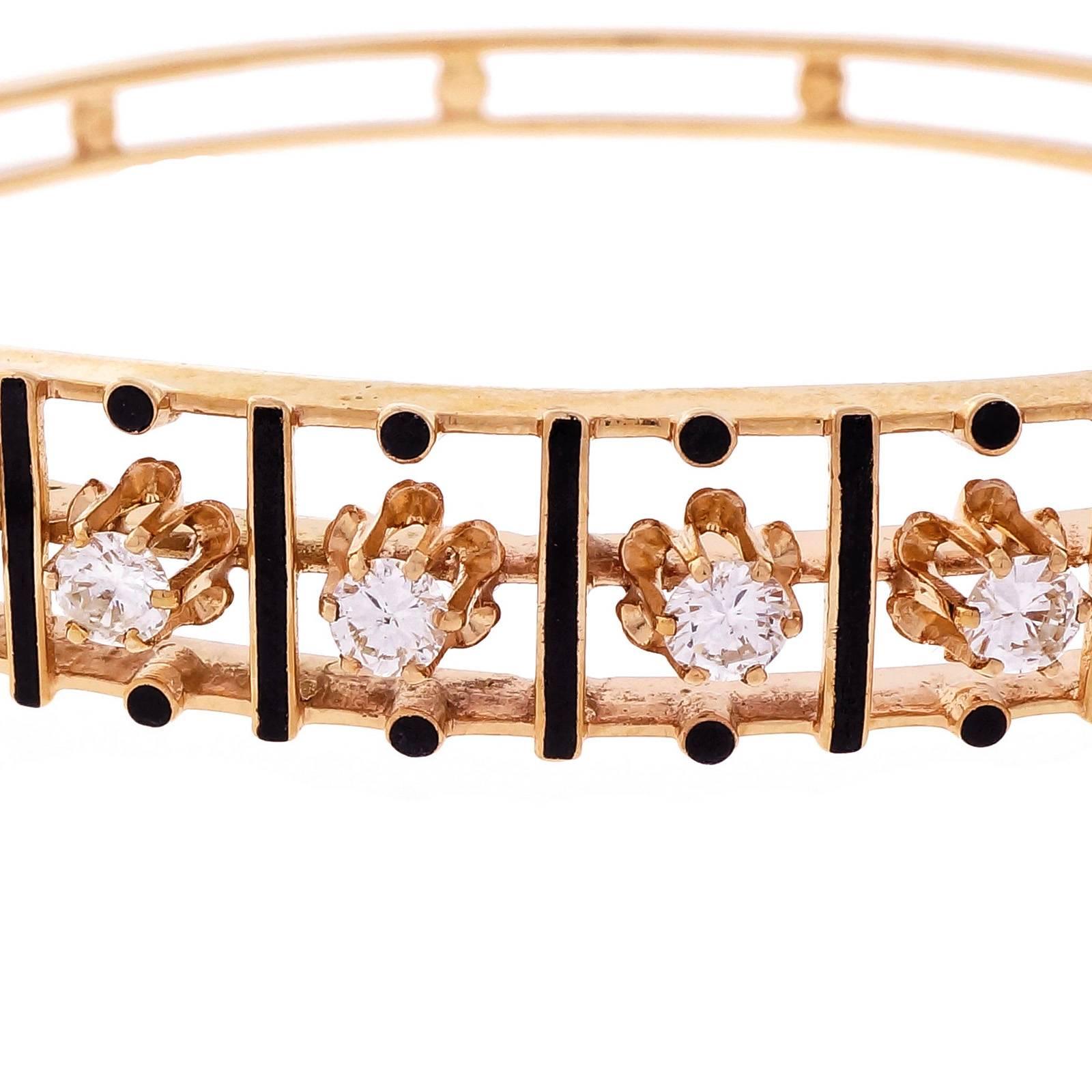 Hinged 1950 14k yellow gold diamond bangle bracelet signed RGJ. Distinctive black enamel and bright diamonds.

7 round diamonds, approx. total weight 1.00cts, H, VS2 – SI1
14k yellow gold
Tested and stamped: 14k
Hallmark: RGJ
17.3 grams
Width