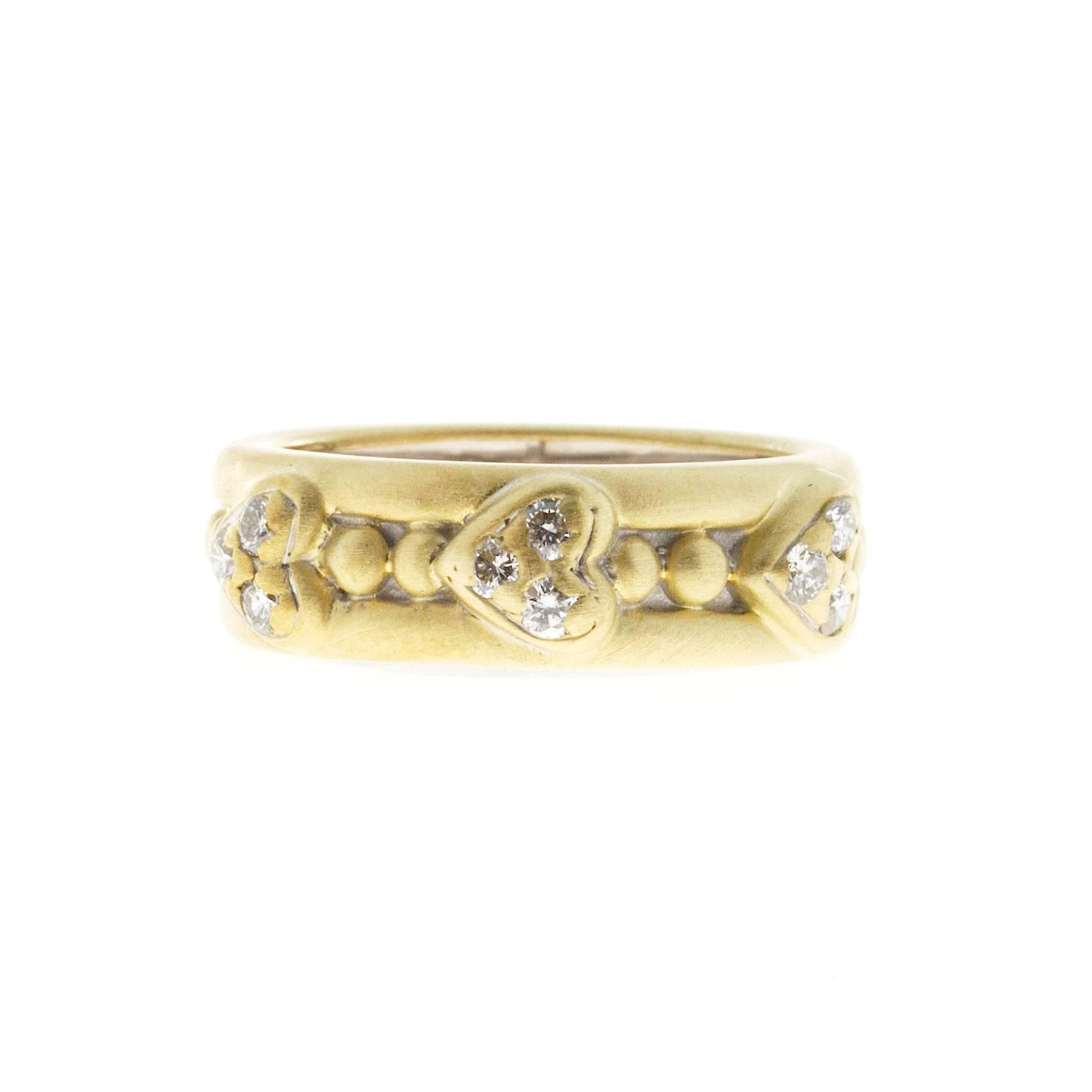 Authentic greenish yellow soft finish Judith Ripka 18k 3 heart 9 diamond band.

9 full cut diamonds, approx. total weight .27cts, H, VS
18k Yellow Gold
Tested and stamped: 18k
© Judith Ripka
Width at top: 6.5mm
Height at top: 3.3mm
Width at