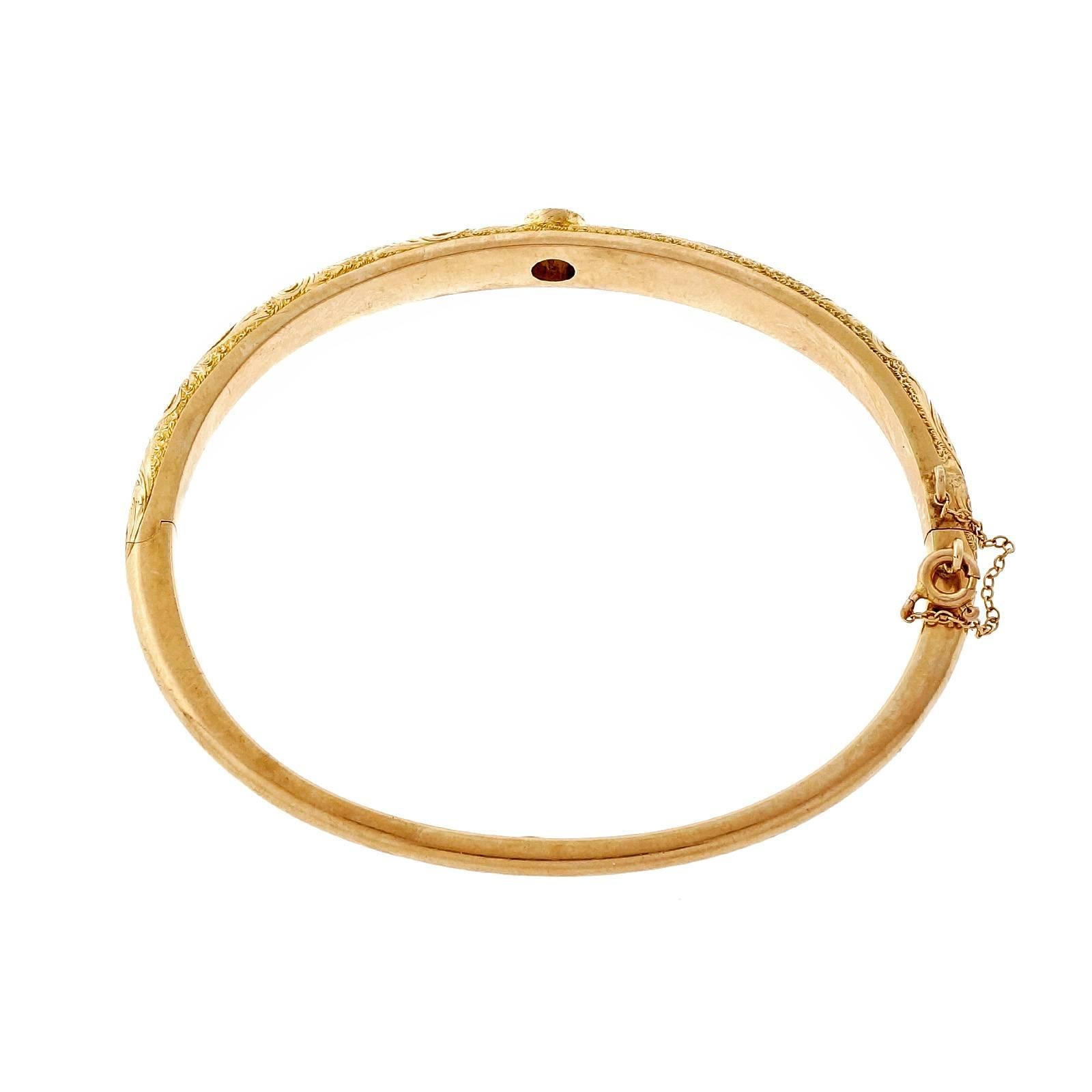 Late Victorian hinged bangle bracelet with engraved top and a bright sparkly old European cut diamond. Secure catch and safety chain. Circa 1900.

1 old European cut diamond¸ approx. total weight .34cts, H, SI1
14k yellow gold
Tested and
