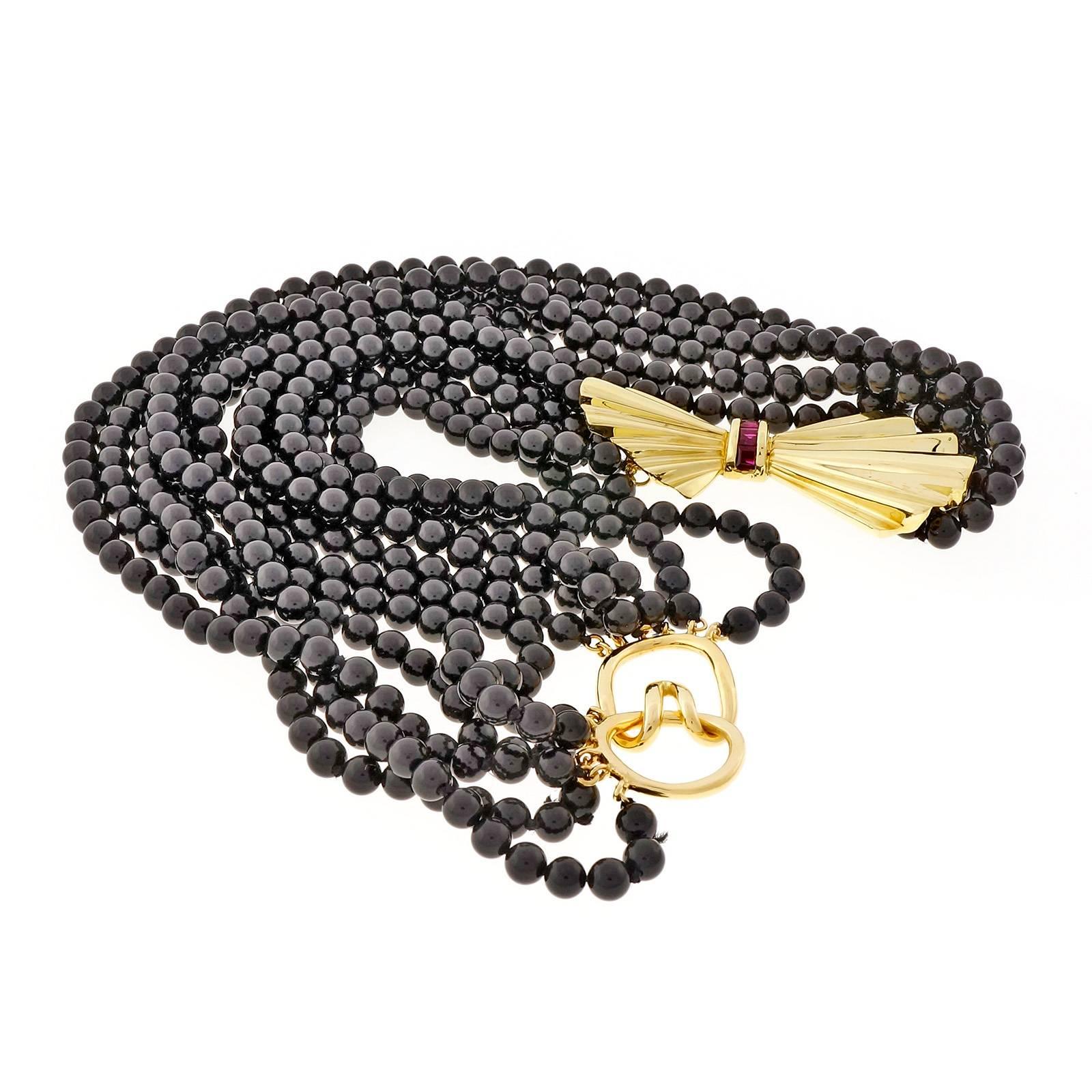 Tiffany & Co 18k yellow gold Ruby 6 row black Onyx bead necklace, circa 1960-1970. 18k clasp. Can be twisted if desired. 17.5 inches

4 square bright red Rubies, approx. total weight 1.20cts, 3mm
510 black Onyx beads, 4.5mm
18k yellow gold
Tested