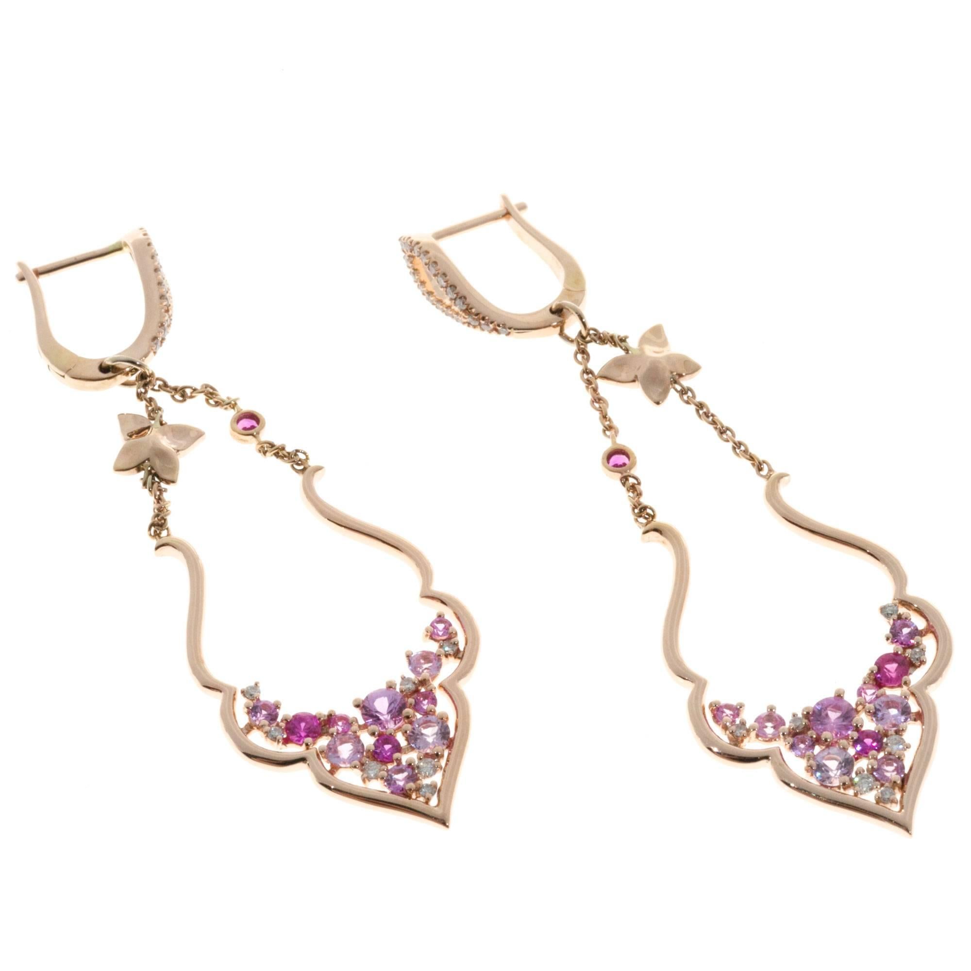 14k Rose gold dangle earrings with pink Sapphires and diamonds.

24 round pink Sapphires, approx. total weight 1.18cts
58 round diamonds, approx. total weight .21cts, H, VS
14k rose gold
Tested: 14k
Stamped: 14k 585
Hallmark: Diamond