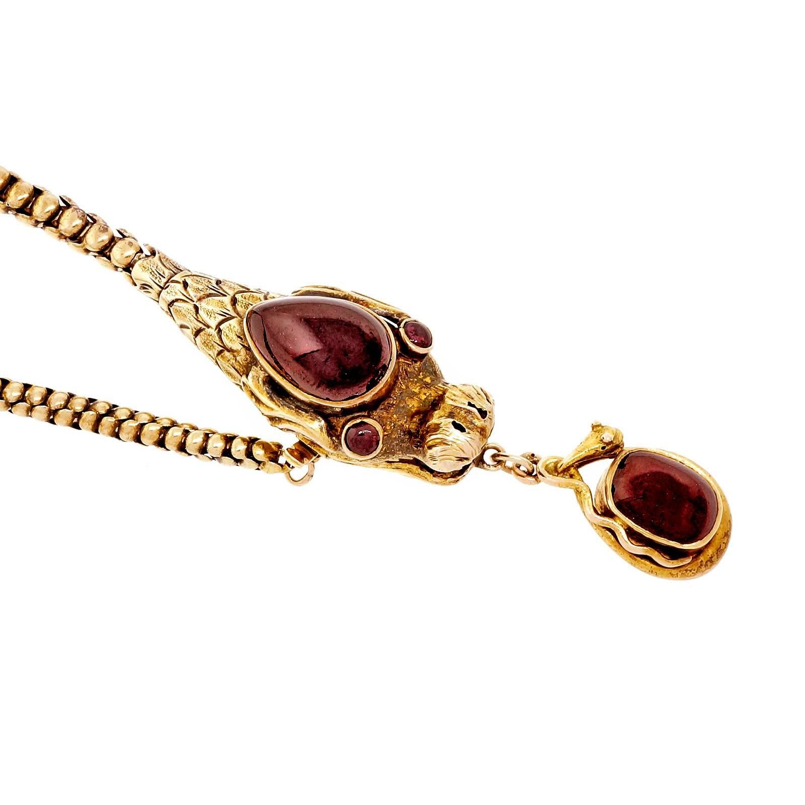Victorian handmade dragon or serpent necklace circa 1880-1889 with cabochon Garnets. A second serpent piece dangles from the mouth.

1 pear reddish brown Garnet, 14.73 x 9.50mm
2 round cabochon Garnets, 2.54mm
1 oval cabochon Garnet, 4.94 x