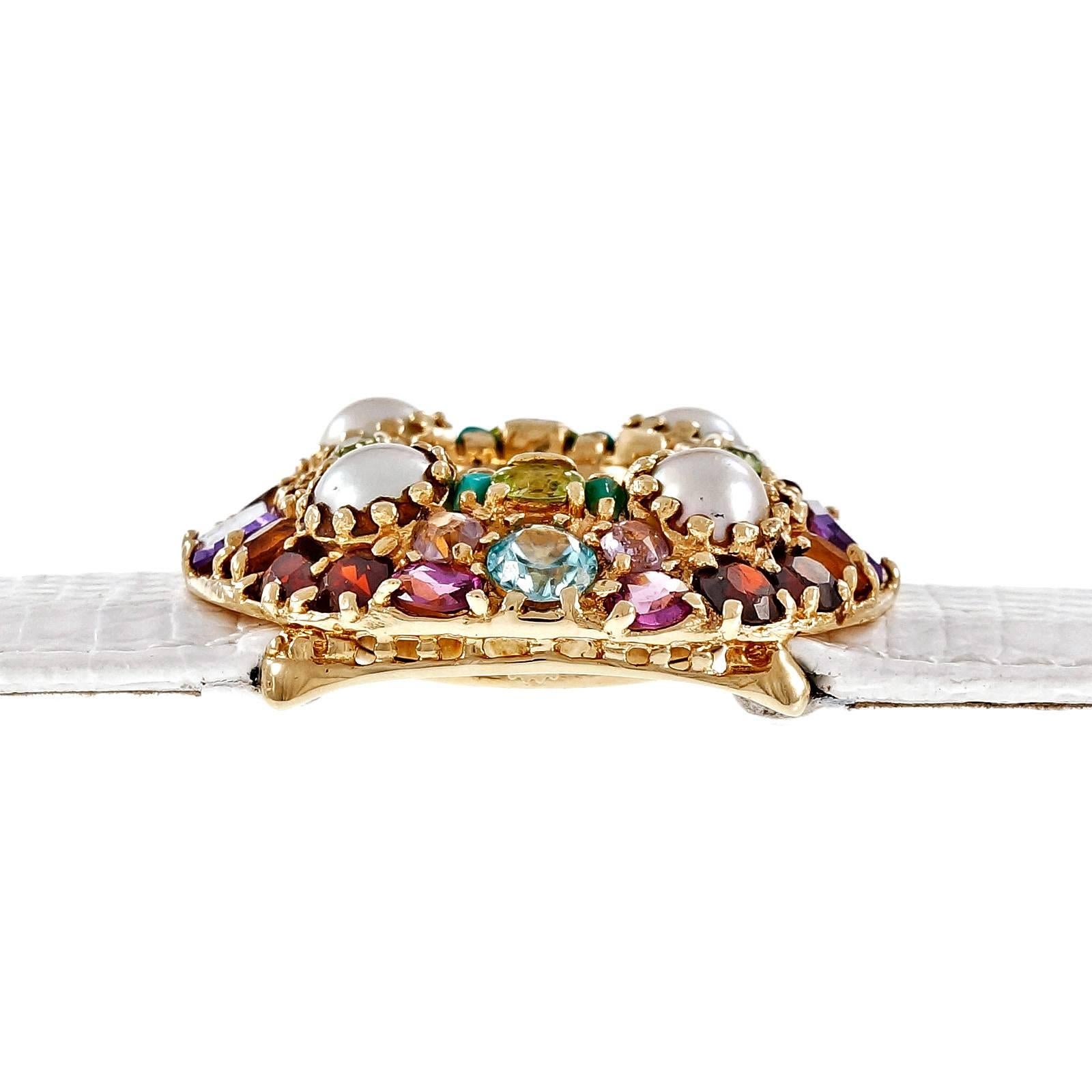 Lucien Piccard 1960’s multi stone multi-color fashion watch in 14k yellow gold with wide white band. Manual wind and 17 jewel movement. Case set with genuine Amethyst, Garnet, Ruby, Turquoise, Blue Zircon, Peridot and Citrine.

14k yellow