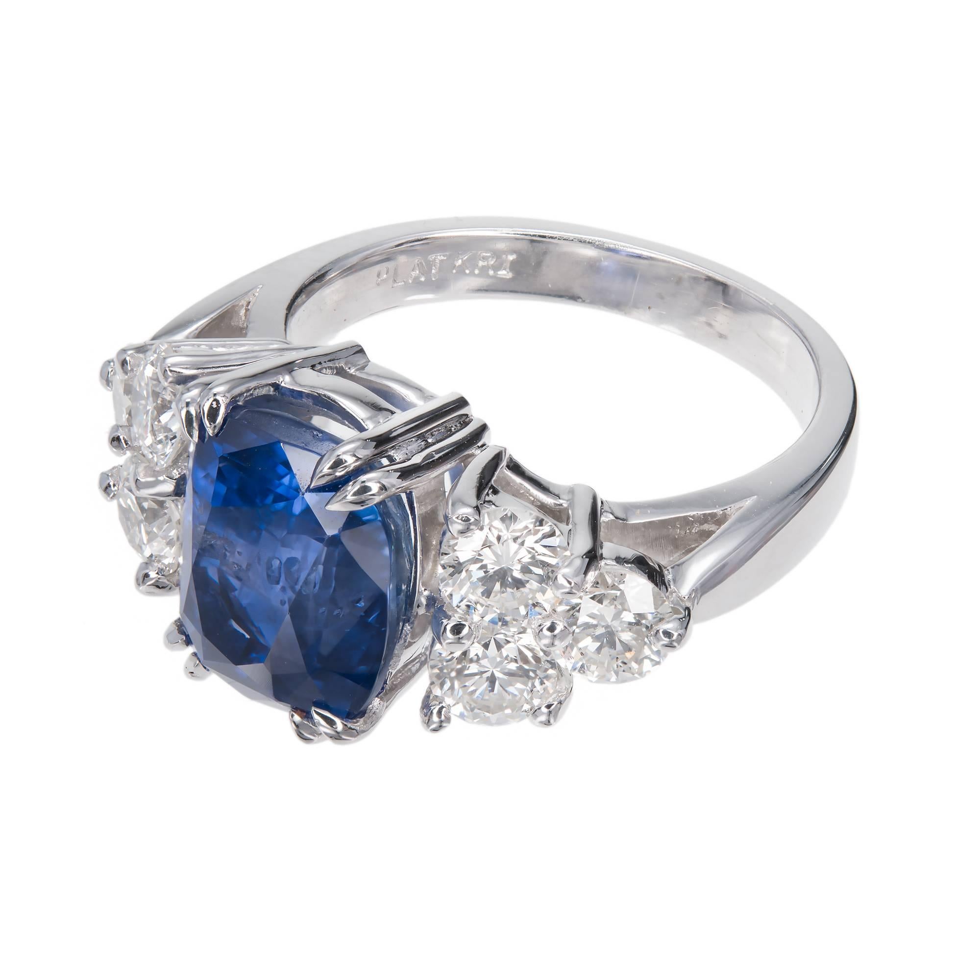 Antique cushion cut sapphire and diamond engagement ring.  GIA certified no heat sapphire center stone with 6 round accent diamonds, in a handmade platinum setting from the Peter Suchy Workshop. 

1 cushion blue Sapphire, approx. total weight