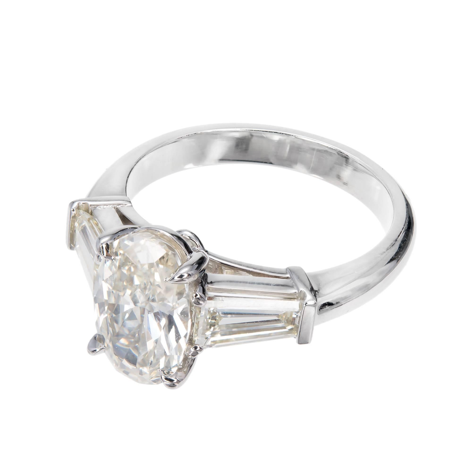 Peter Suchy oval diamond engagement ring. Side diamond baguettes that match perfectly for a one of a kind ring.

1 oval diamond, approx. total weight 1.67cts, M, SI2, GIA certificate #1176626871
2 tapered baguette diamonds, approx. total weight