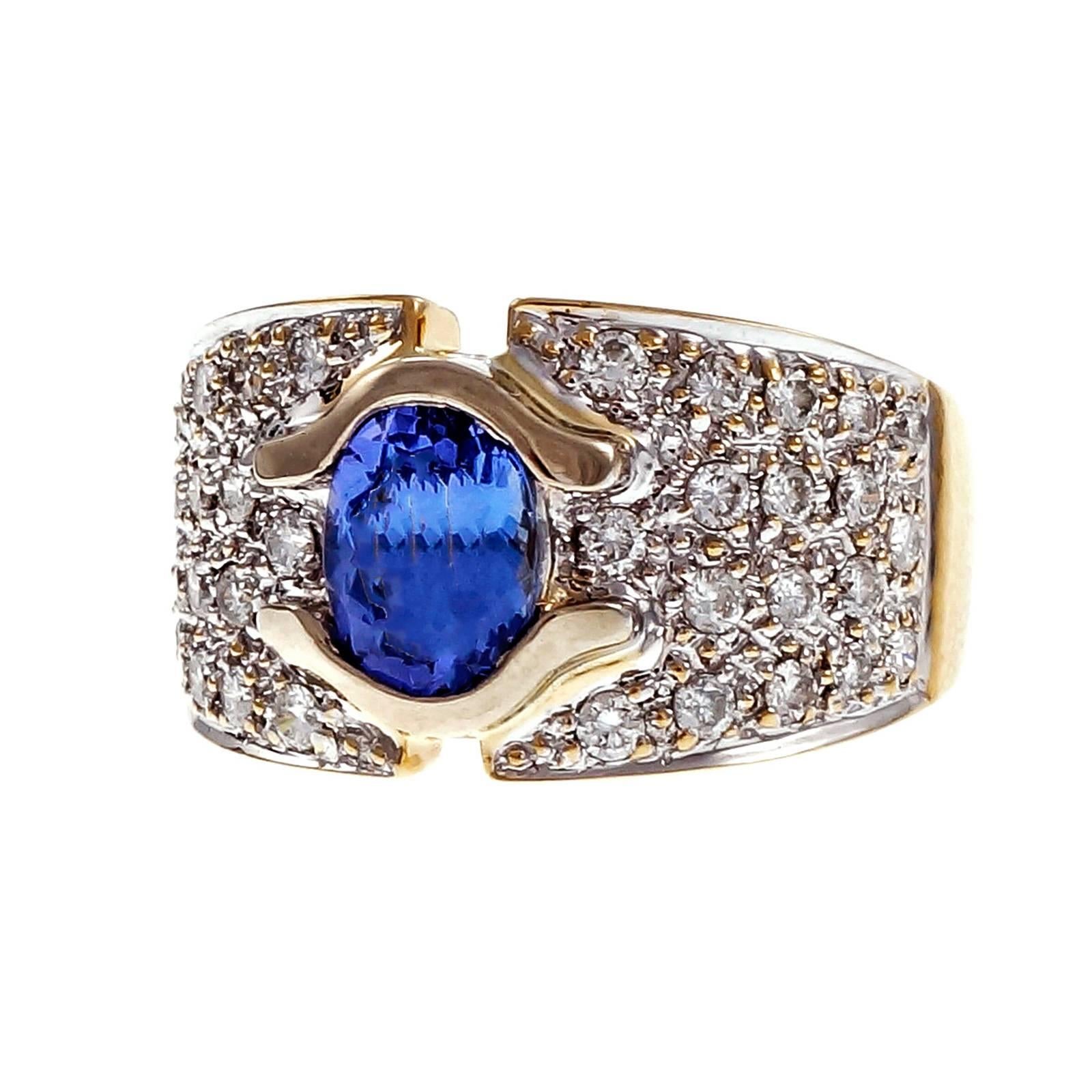 Tanzanite Pavé diamond 18k yellow gold ring. Sits low to the finger.

1 oval purple blue Tanzanite, approx. total weight 1.50cts, VS, 7.44 x 6.05mm
36 round diamonds, approx. total weight .72cts, H, VS – SI
18k yellow gold
Tested and stamped: