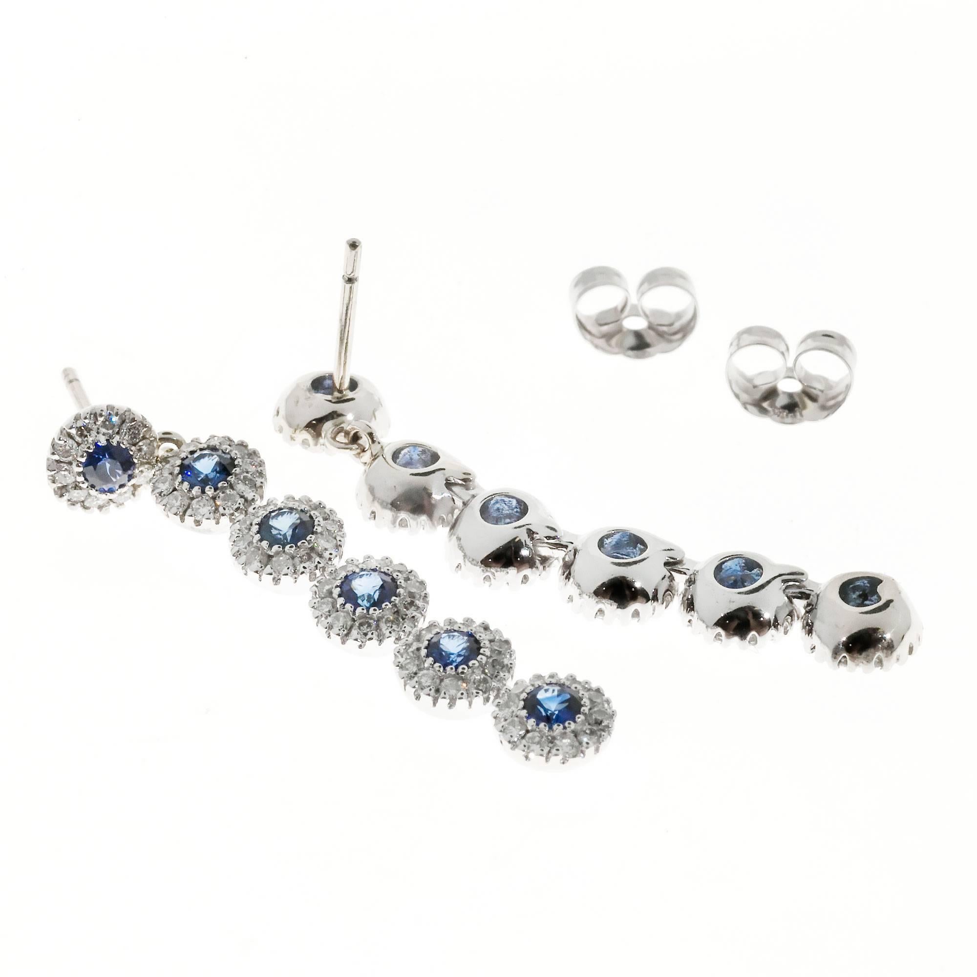 Six section 14k white gold Sapphire diamond halo long dangle earrings.

120 full cut diamonds, approx. total weight .60cts, G, SI1
12 2.2mm genuine bright blue Sapphires, approx. total weight .60cts
14k White Gold
Tested: 14k
4.3 grams
Top to