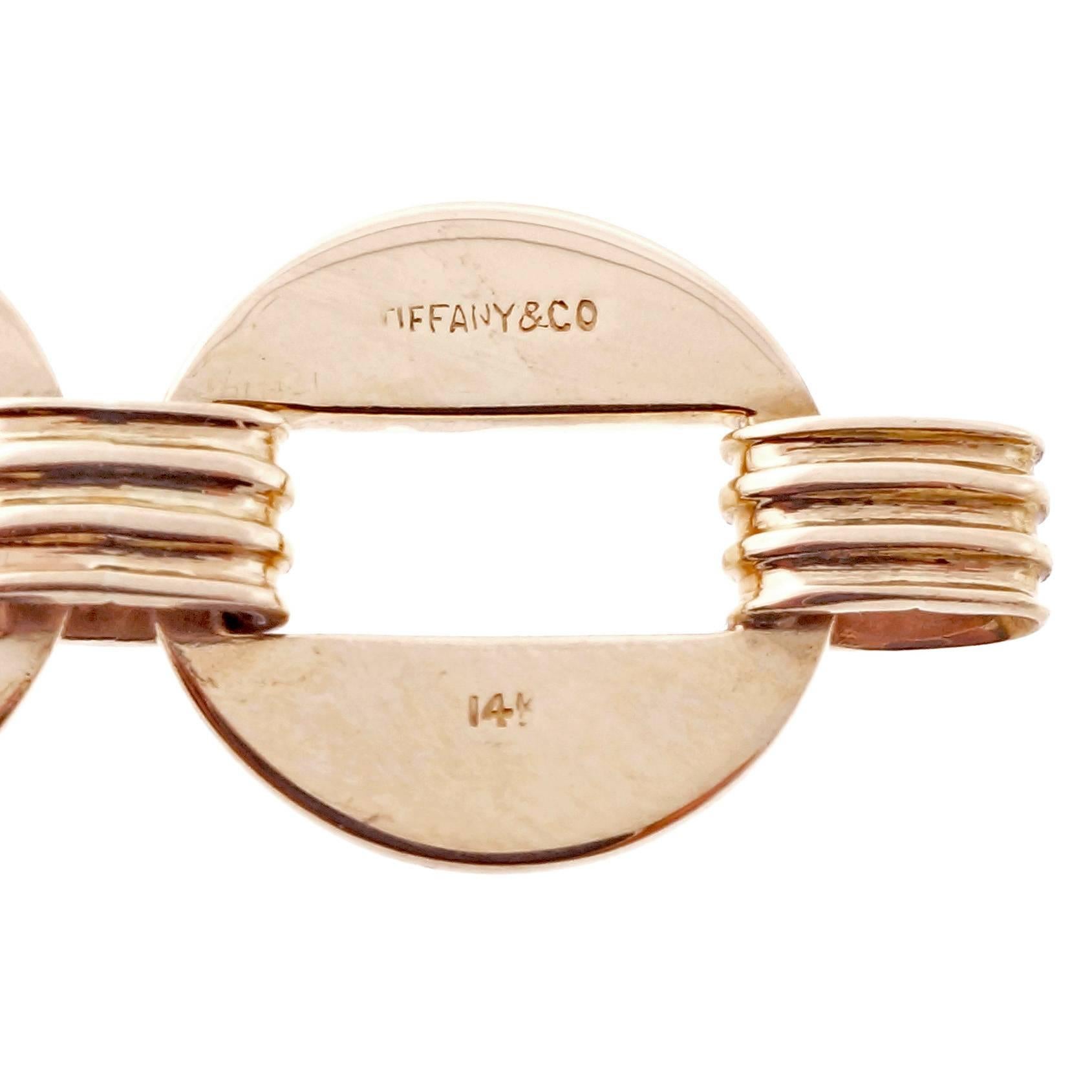 Tiffany & Co. 1940’s 14k yellow gold link bracelet.

14k yellow gold
Tested and stamped: 14k
31.3 grams
Width: 15.60mm or .70 inch
Hallmark: Tiffany & Co.
Chain: Length: 7.5 inches – Width: 5.60mm - Depth: 4.36mm
