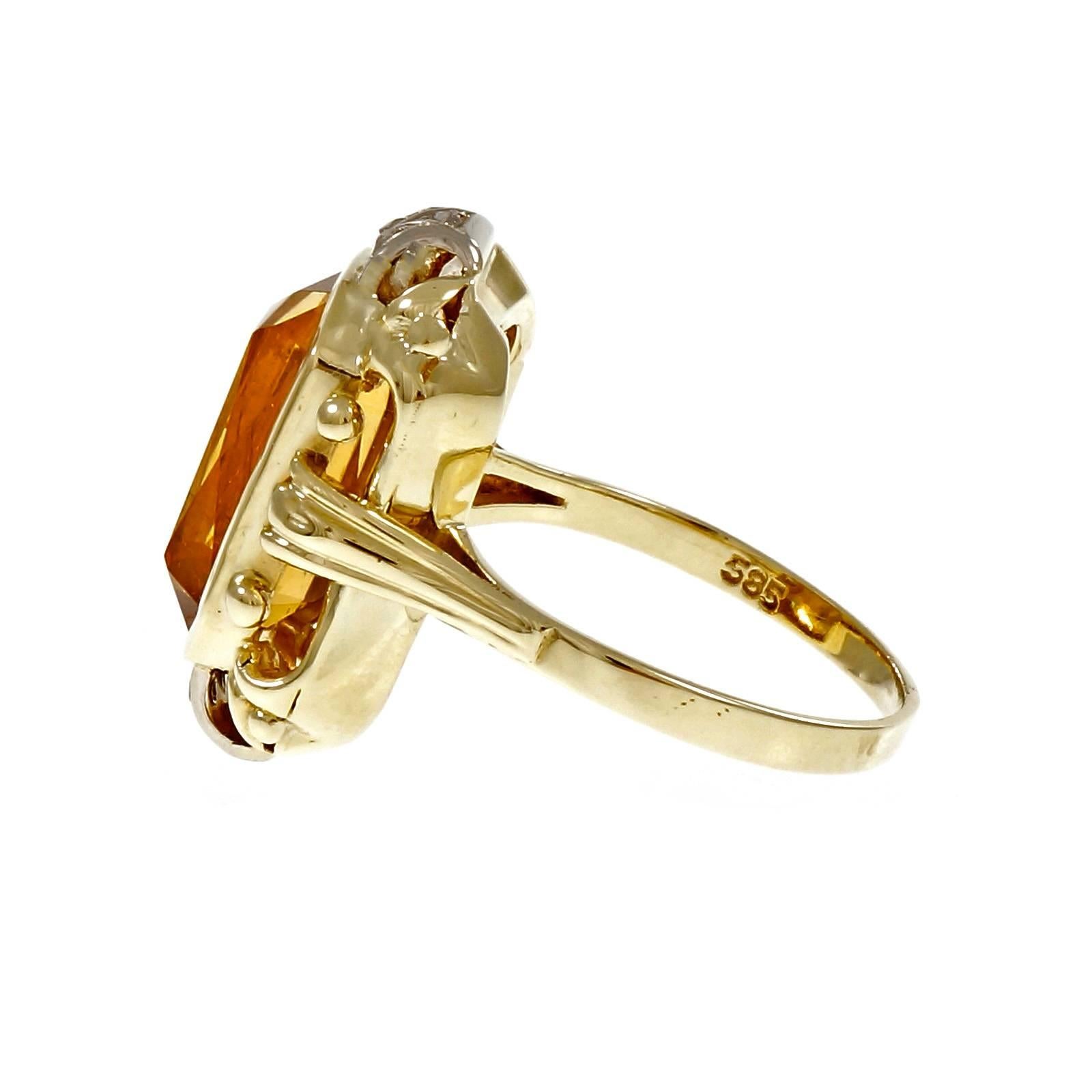 Octagonal Orange Citrine Diamond Gold Cocktail Ring.  with 6 rose cut diamonds and a bright orange yellow well-polished Citrine. 

1 octagonal orange yellow Citrine, approx. total weight 6.00cts, 13.19 x 8.90 x 6.75mm
6 rose cut diamonds, approx.