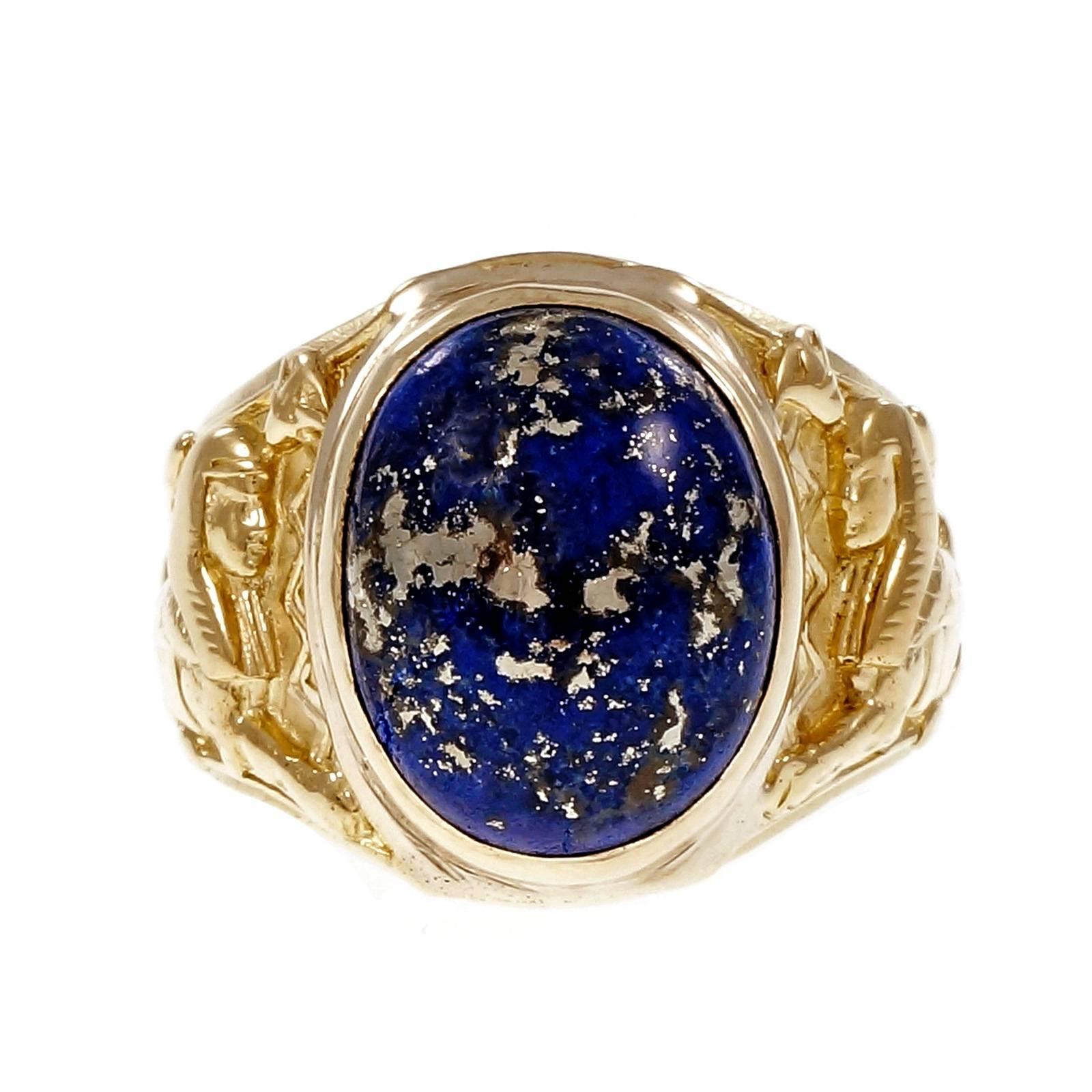 Egyptian Revival heavy solid 18k yellow gold ring with a blue GIA certified natural Lapis with Iron Pyrite flecks. 14k yellow gold bezel. Circa 1920-1929.

1 oval cabochon Lapis, 14.27 x 11.28 x 7.13mm, GIA certificate #2175709264
18k yellow