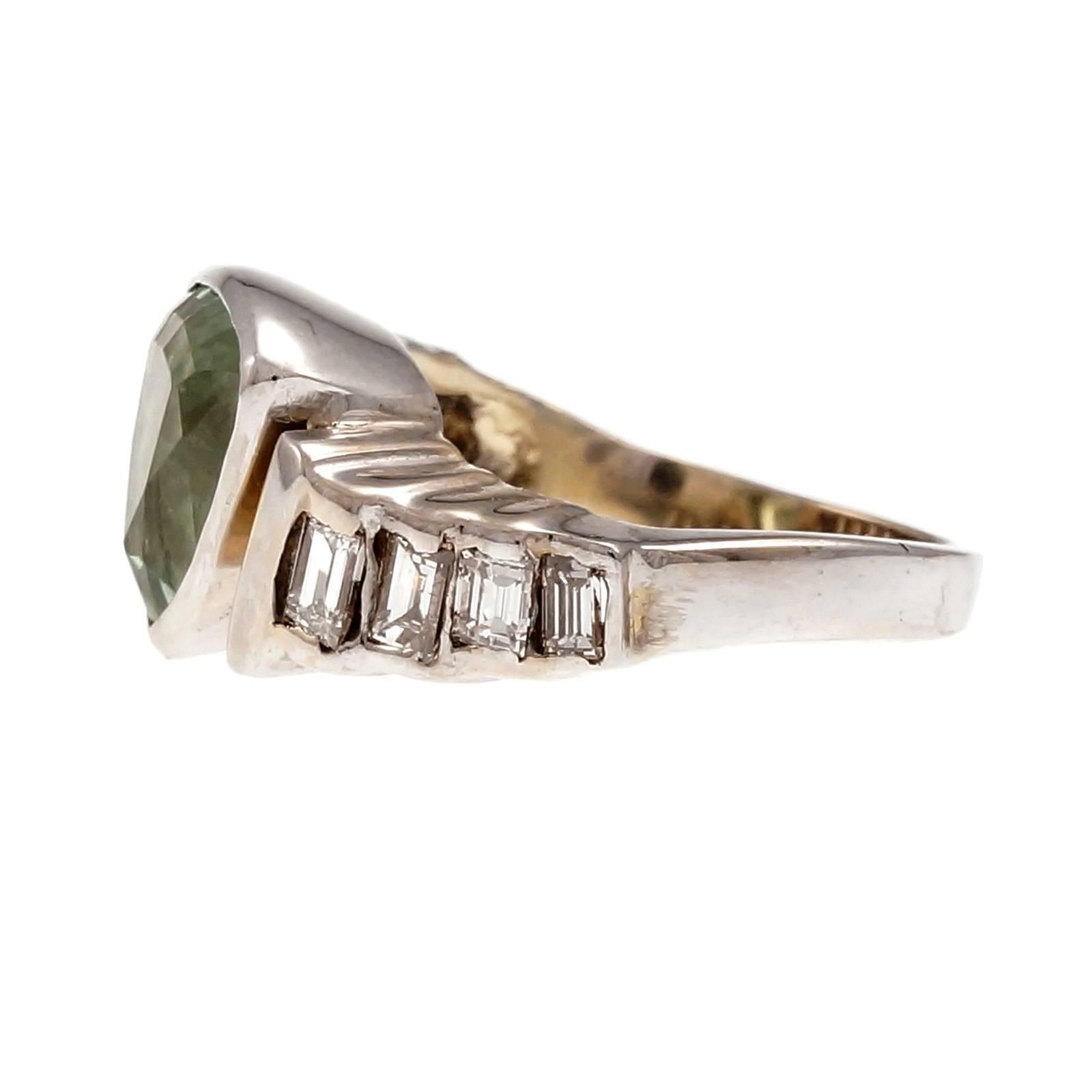 Mint yellow green natural Tsavorite Garnet 1950-1960 14k white gold ring. Bezel set with baguette diamond sides. GIA certified.

1 triangular mint green Tsavorite Garnet, approx. total weight 3.52cts, VS, 3.69 x 2.83 x 2.03 x 1,83mm, GIA certificate