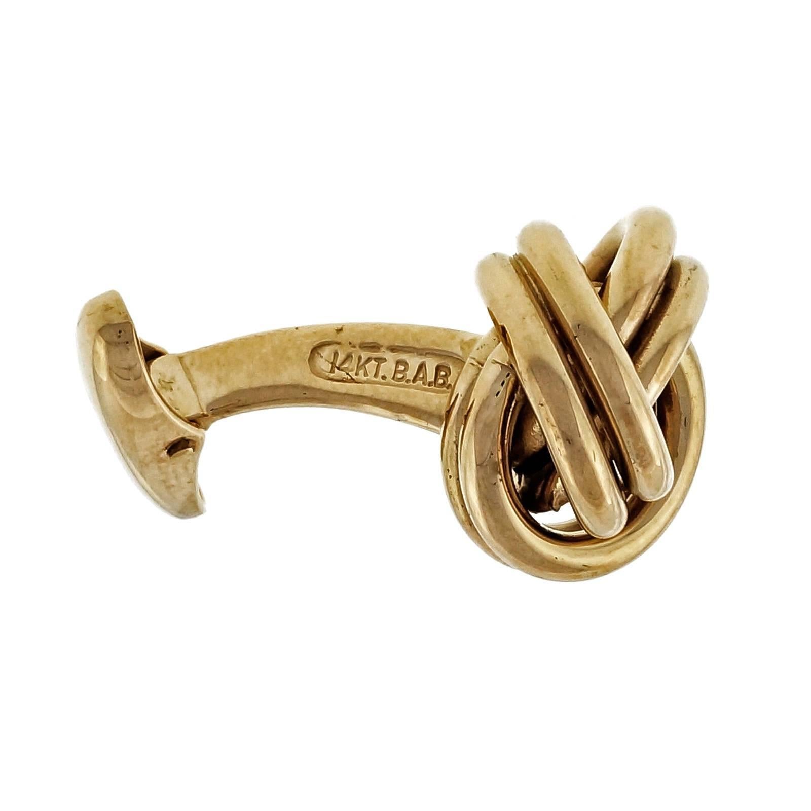 B. A. Ballou clip back knot 14 yellow gold cufflinks.

14k yellow gold
Tested and stamped: 14k
Hallmark: BAB
9.4 grams
Top to bottom: 14.48mm or .57 inch
Width: 15.12mm or .59 inch
Depth: 8.92mm
