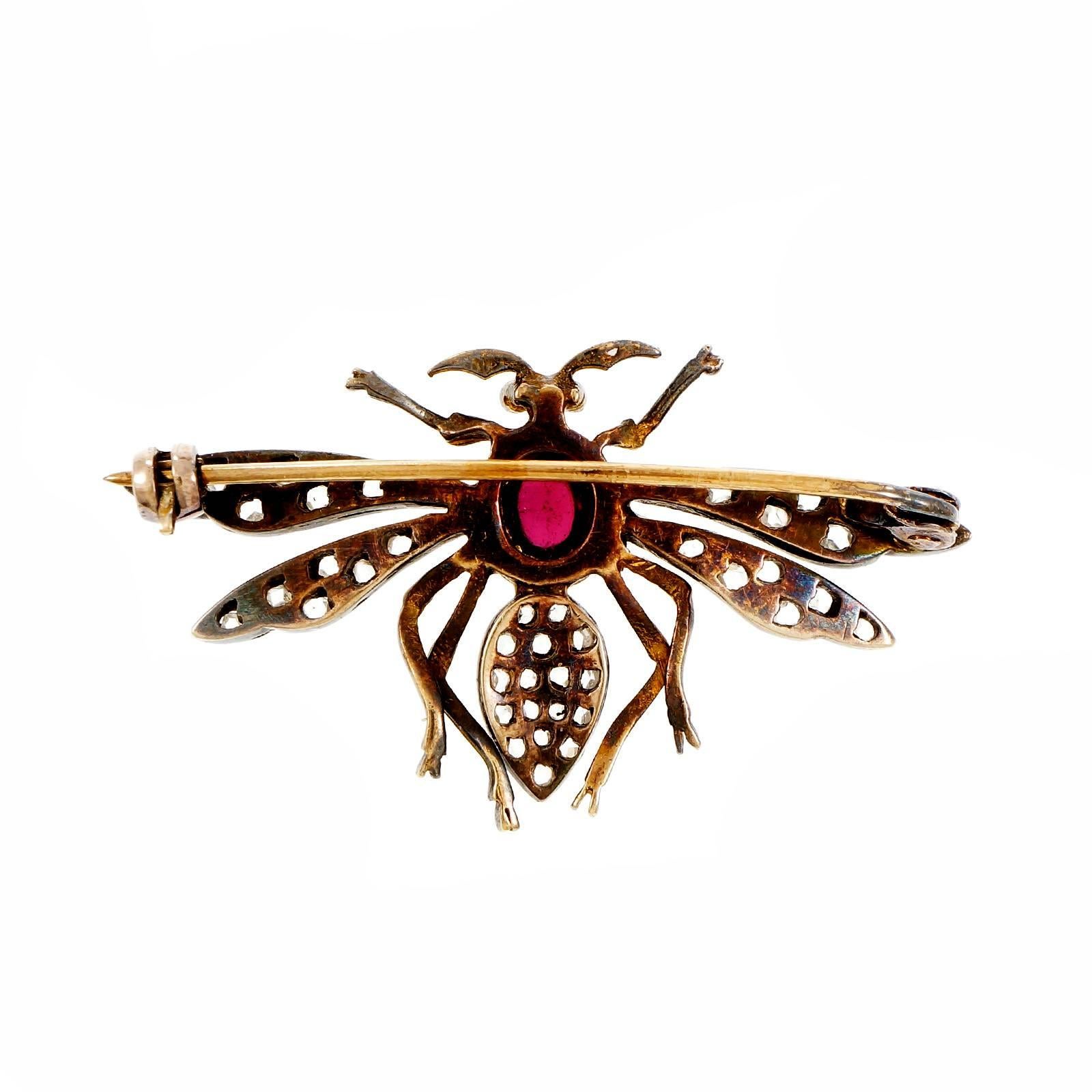 Victorian 1900 wasp pin in 14k yellow gold with natural patina and silver top set with rose cut diamonds and a cabochon Garnet.

1 oval cabochon brownish red Garnet, approx. total weight 1.00cts, 7 x 5.5mm
41 rose cut diamonds, approx. total